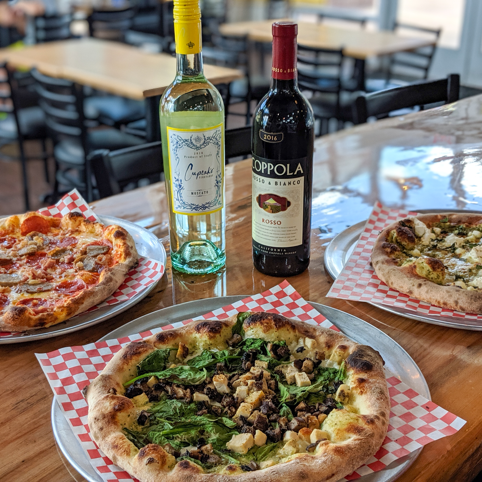 pizza and bottle of wine on table