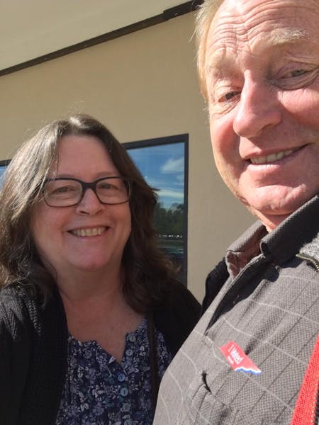 a man and a woman smiling for the camera