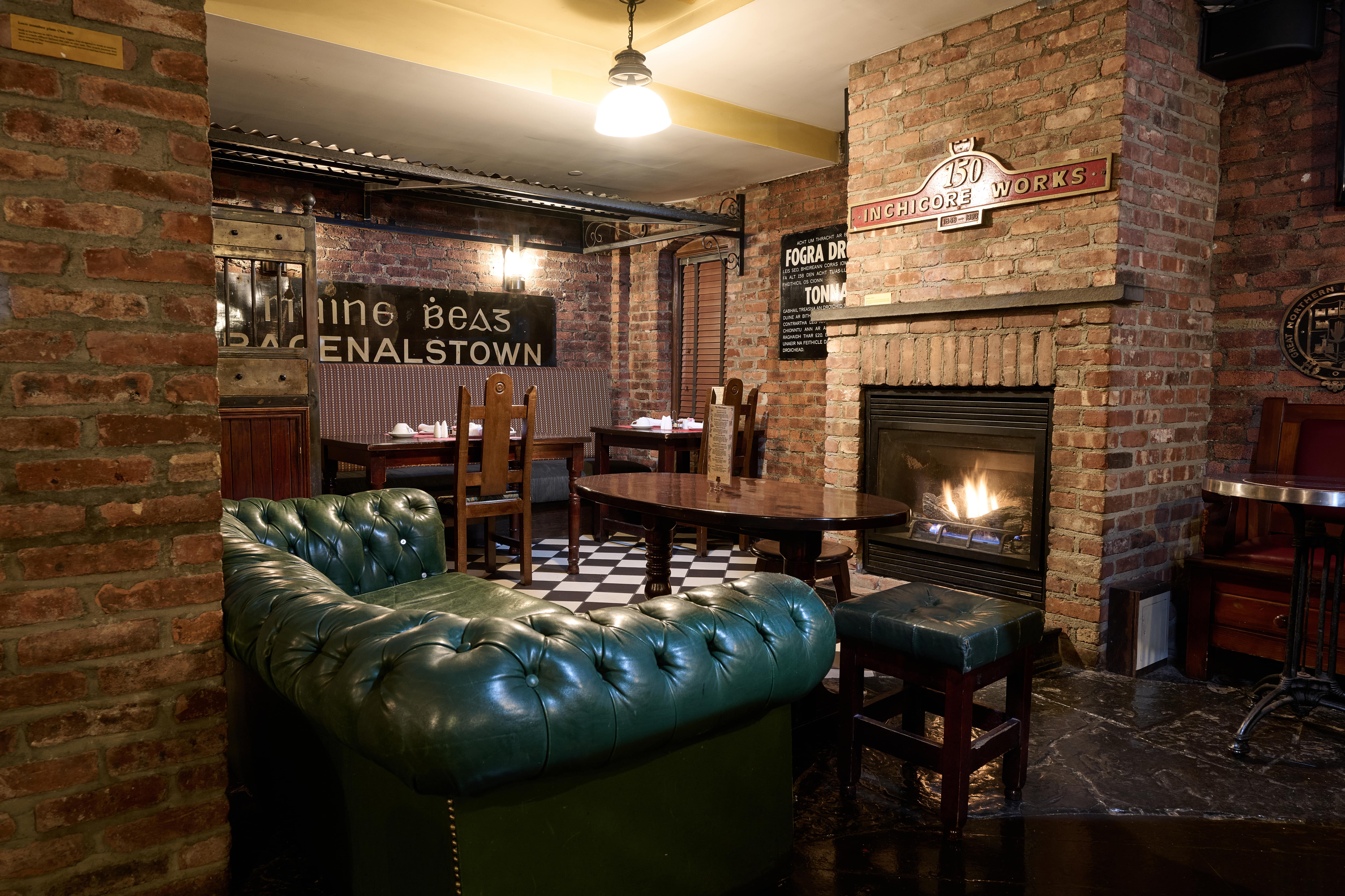a living room with a brick wall