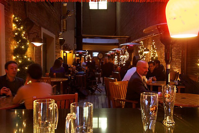 a group of people sitting at a table with wine glasses