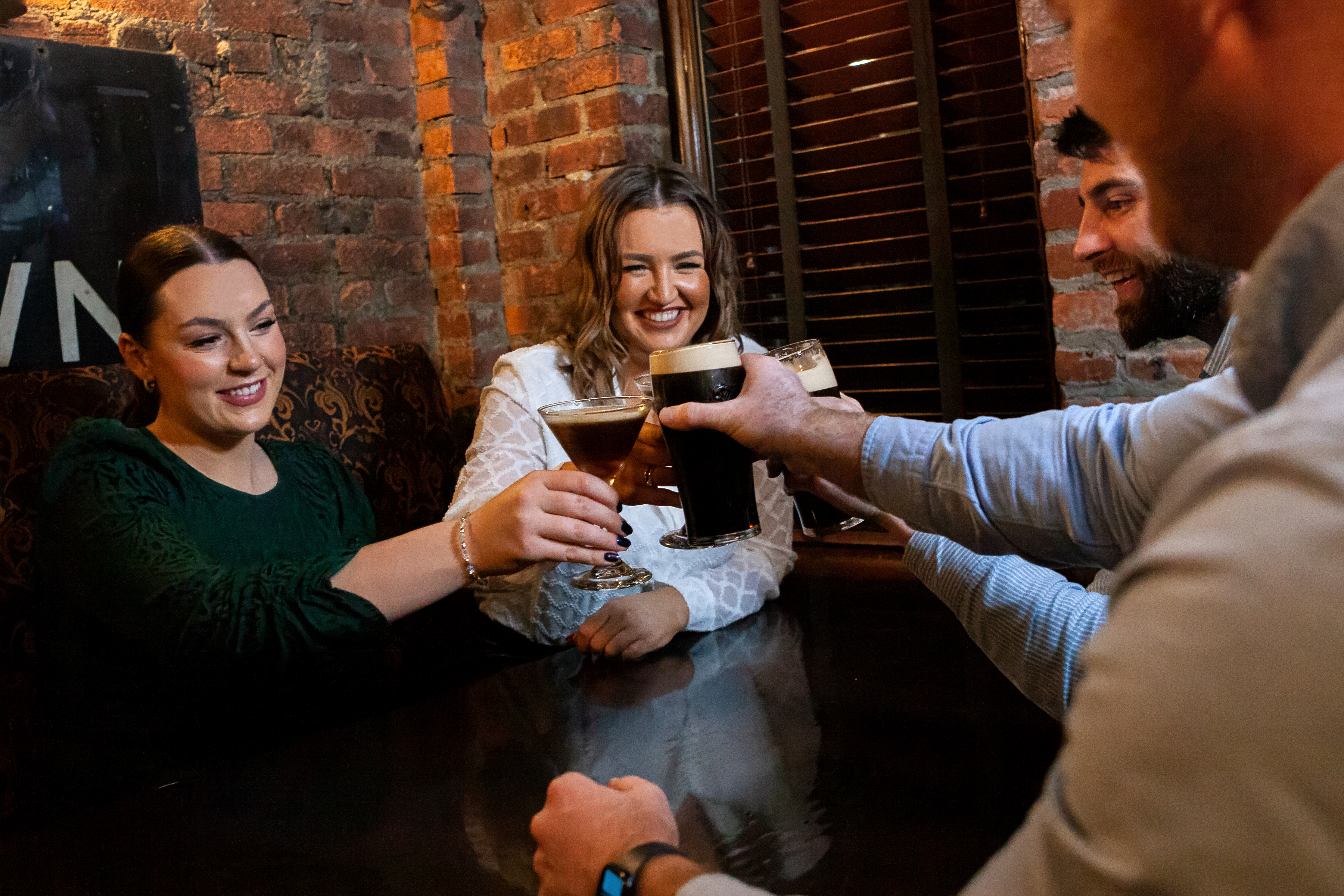 a group of people holding wine glasses