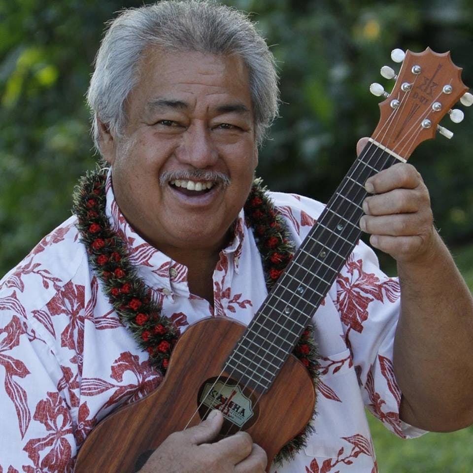 George Kahumoku Jr. holding a guitar
