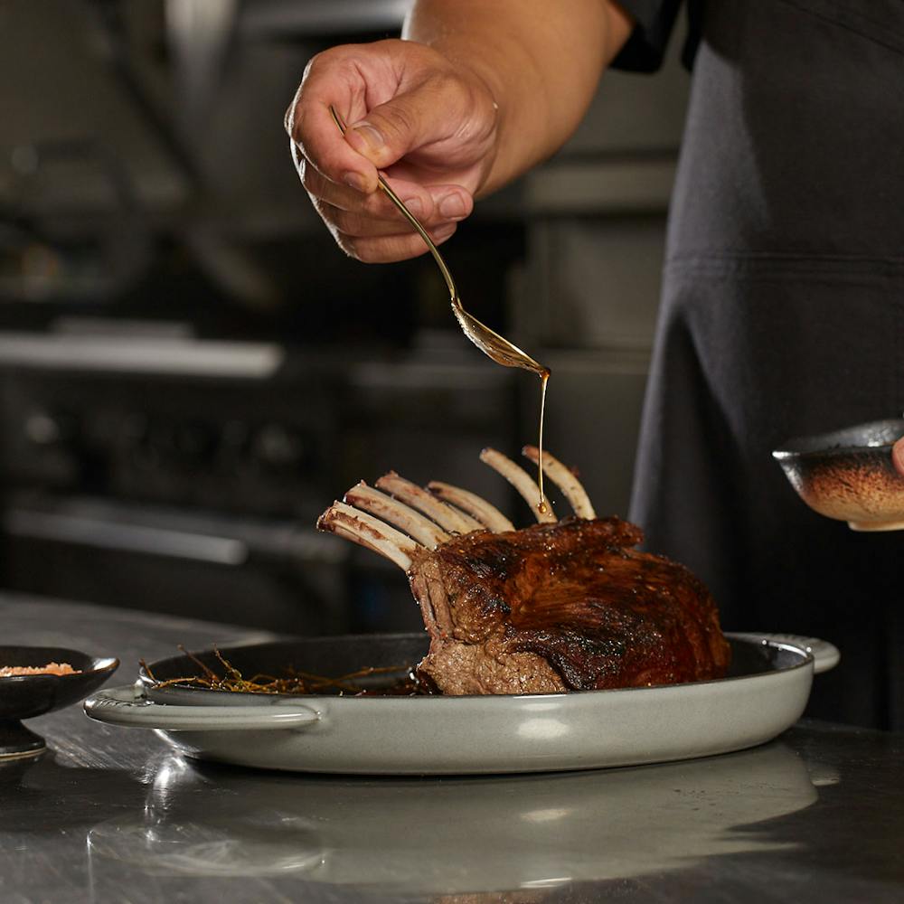a man cutting food on a plate
