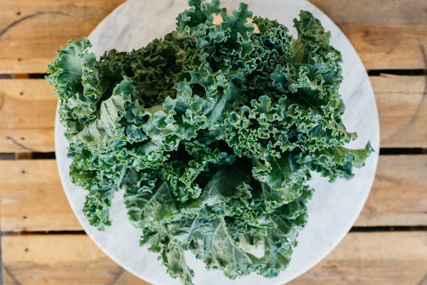 a piece of broccoli sitting on top of a wooden table