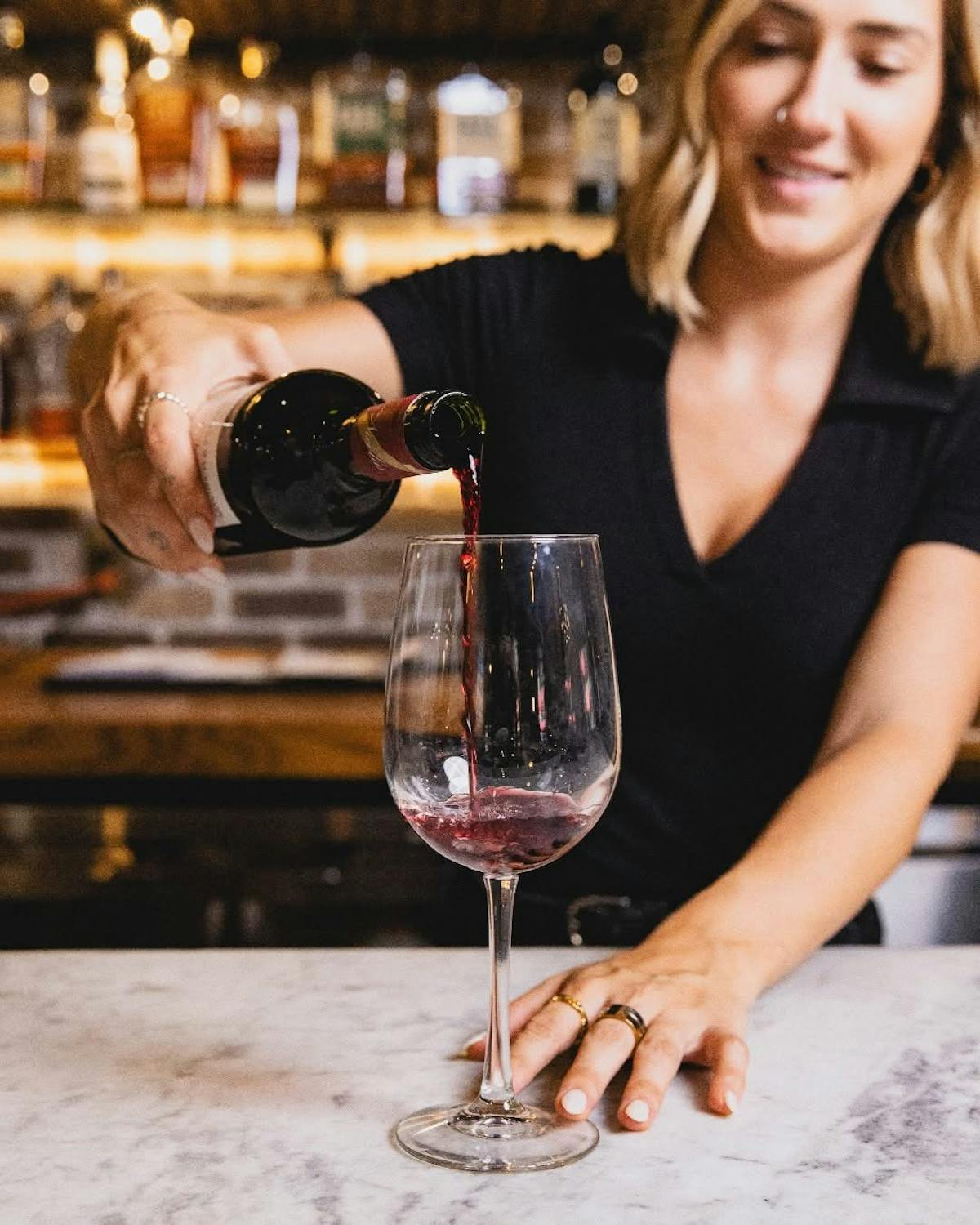 woman pouring wine on glass