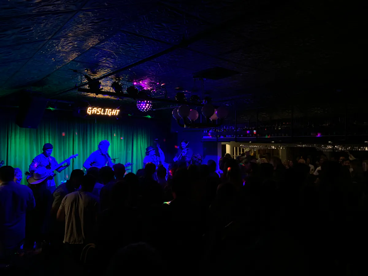 a group of people on a stage with a crowd watching