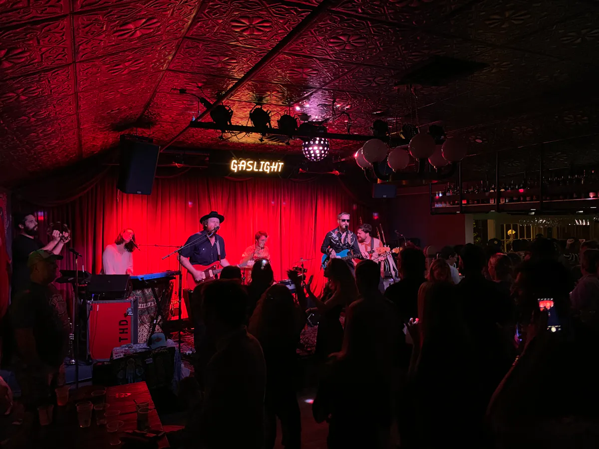 a group of people standing on a stage in front of a crowd