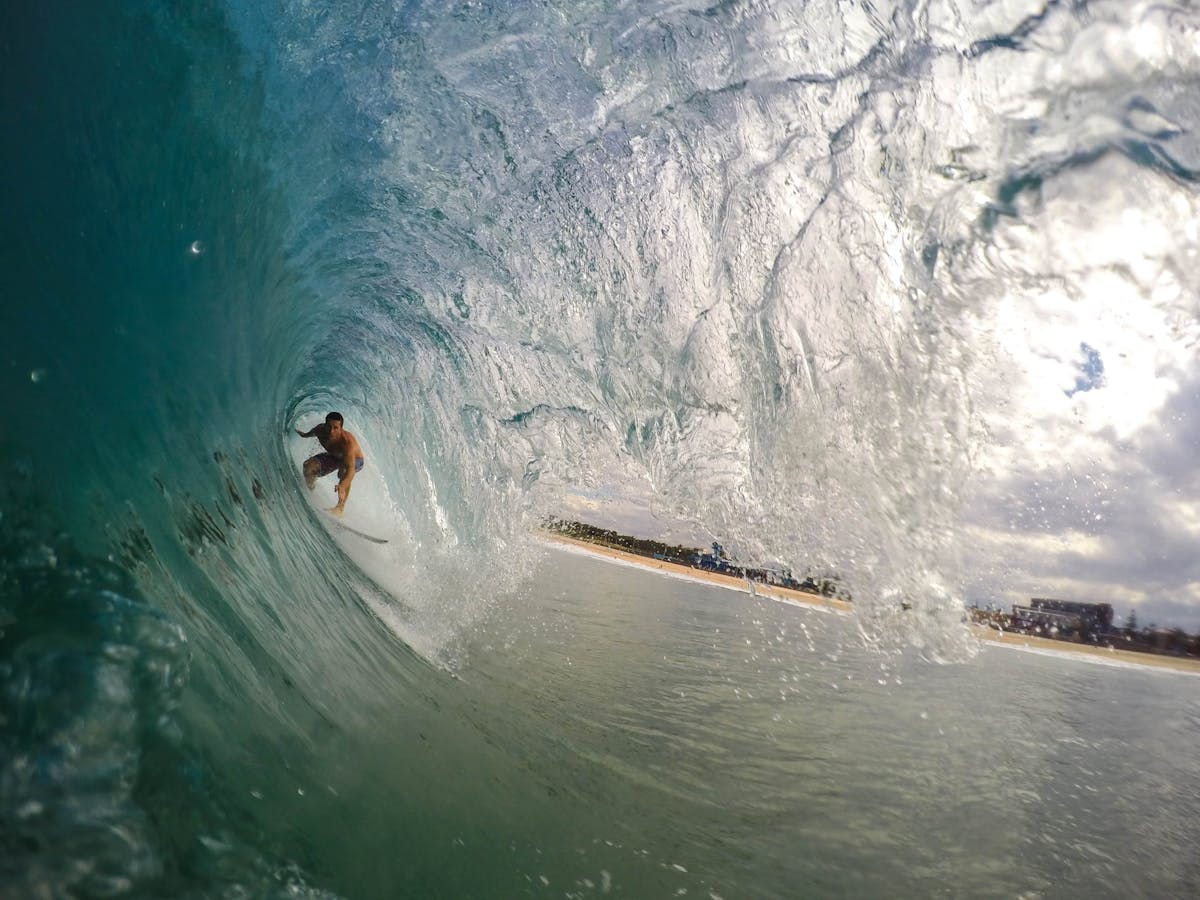 a man riding a wave on a surfboard in the water