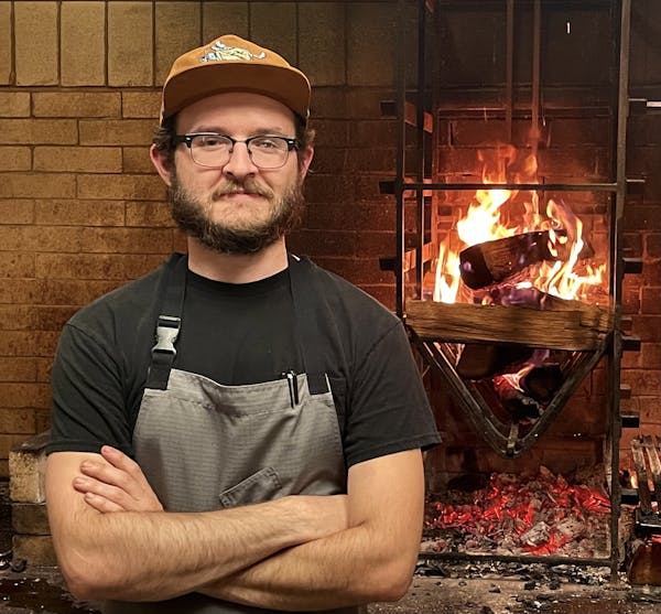 Andreas Schneider sitting in front of a fireplace