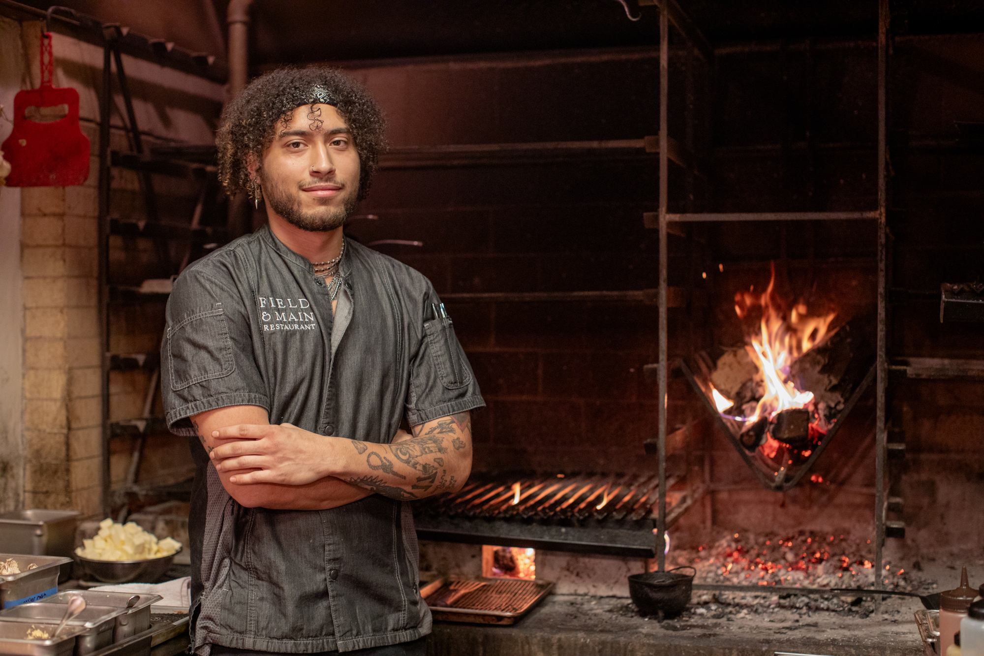 a man standing in front of a fireplace