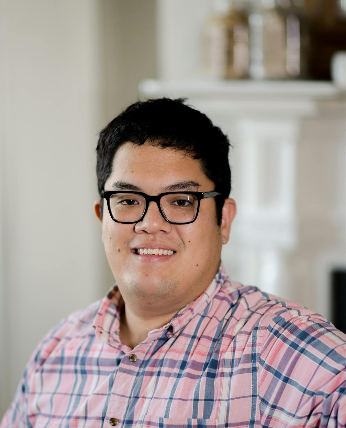a man in glasses looking at the camera