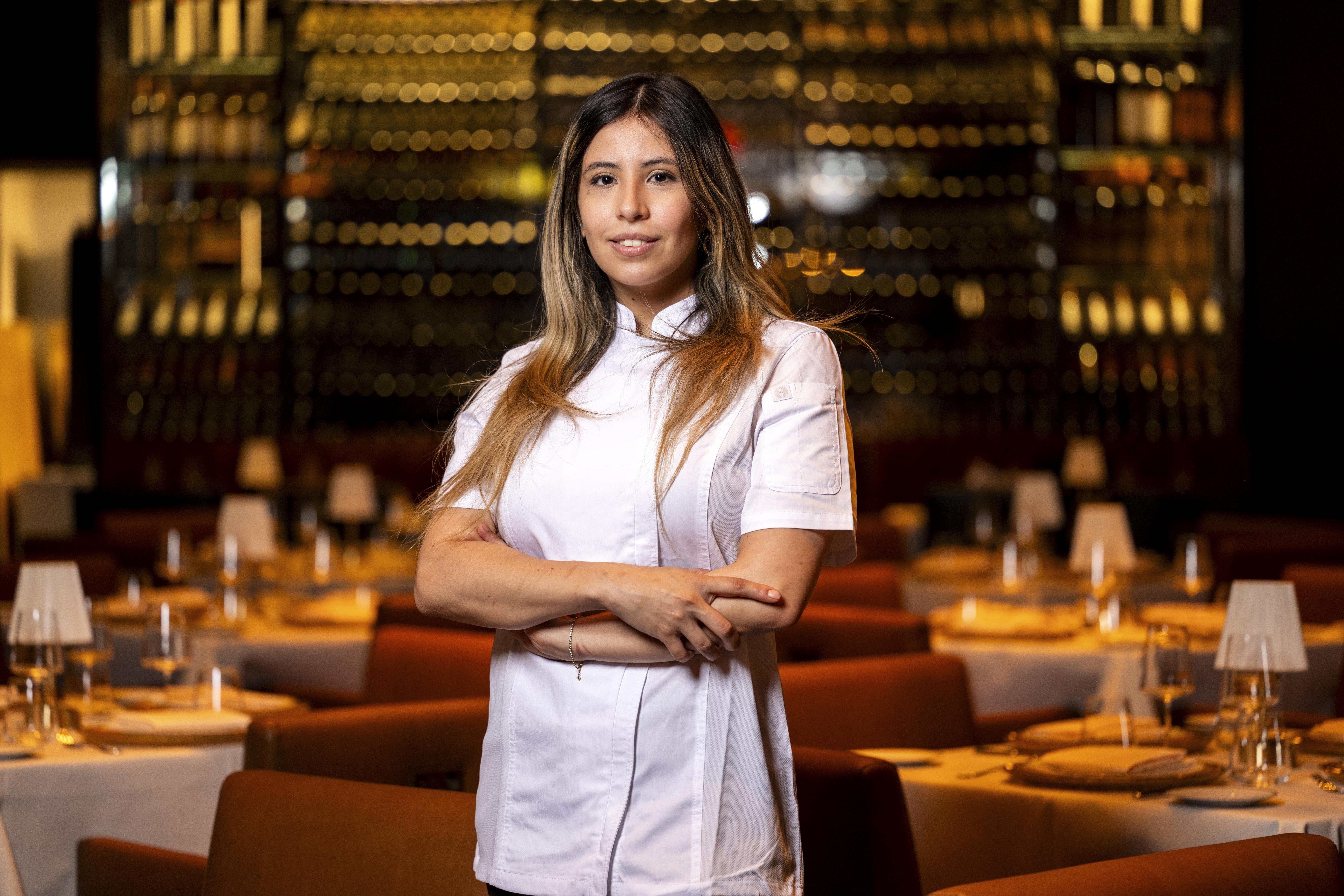 a woman sitting at a table in a restaurant