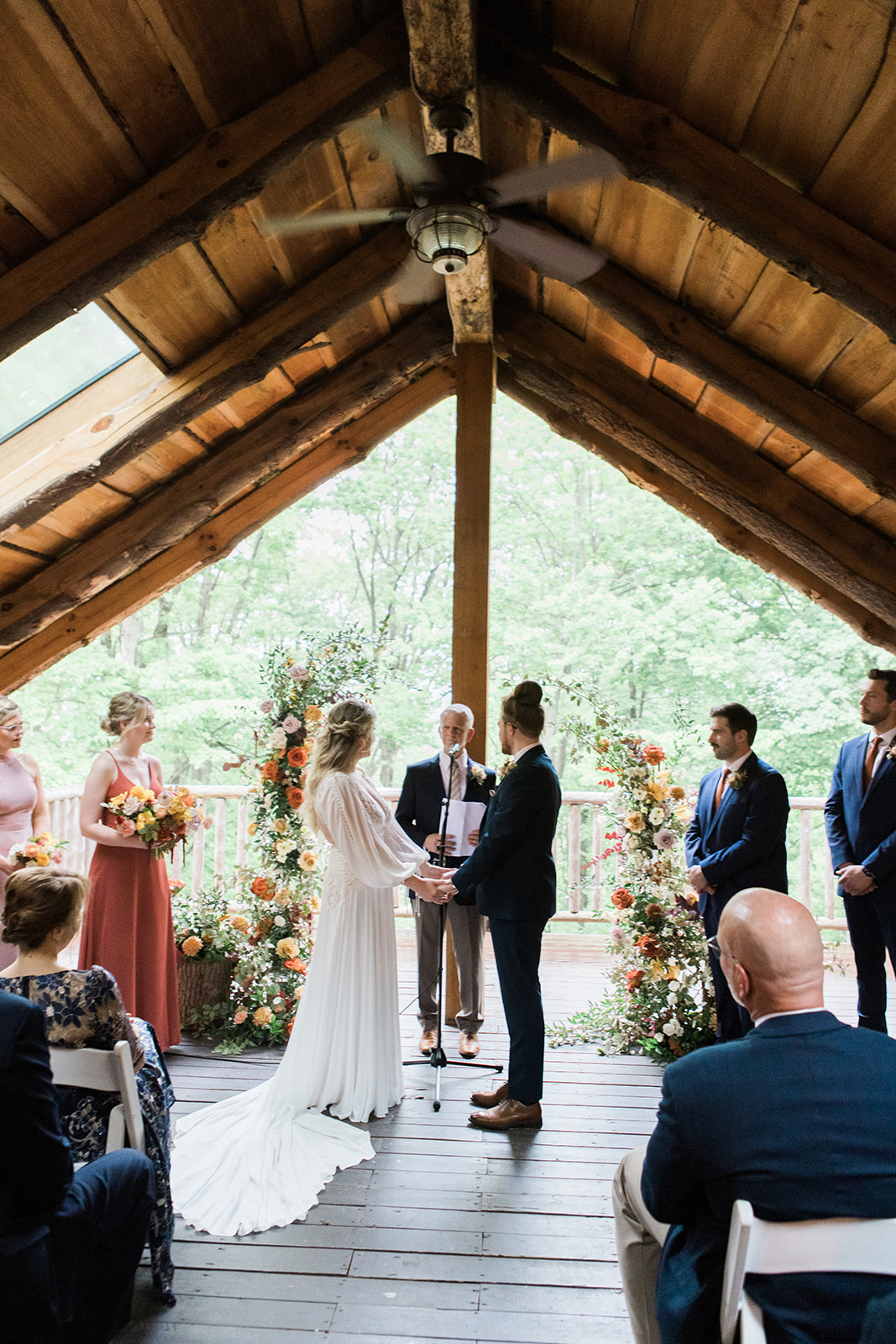 a bride and groom holding hands in a wedding ceremony