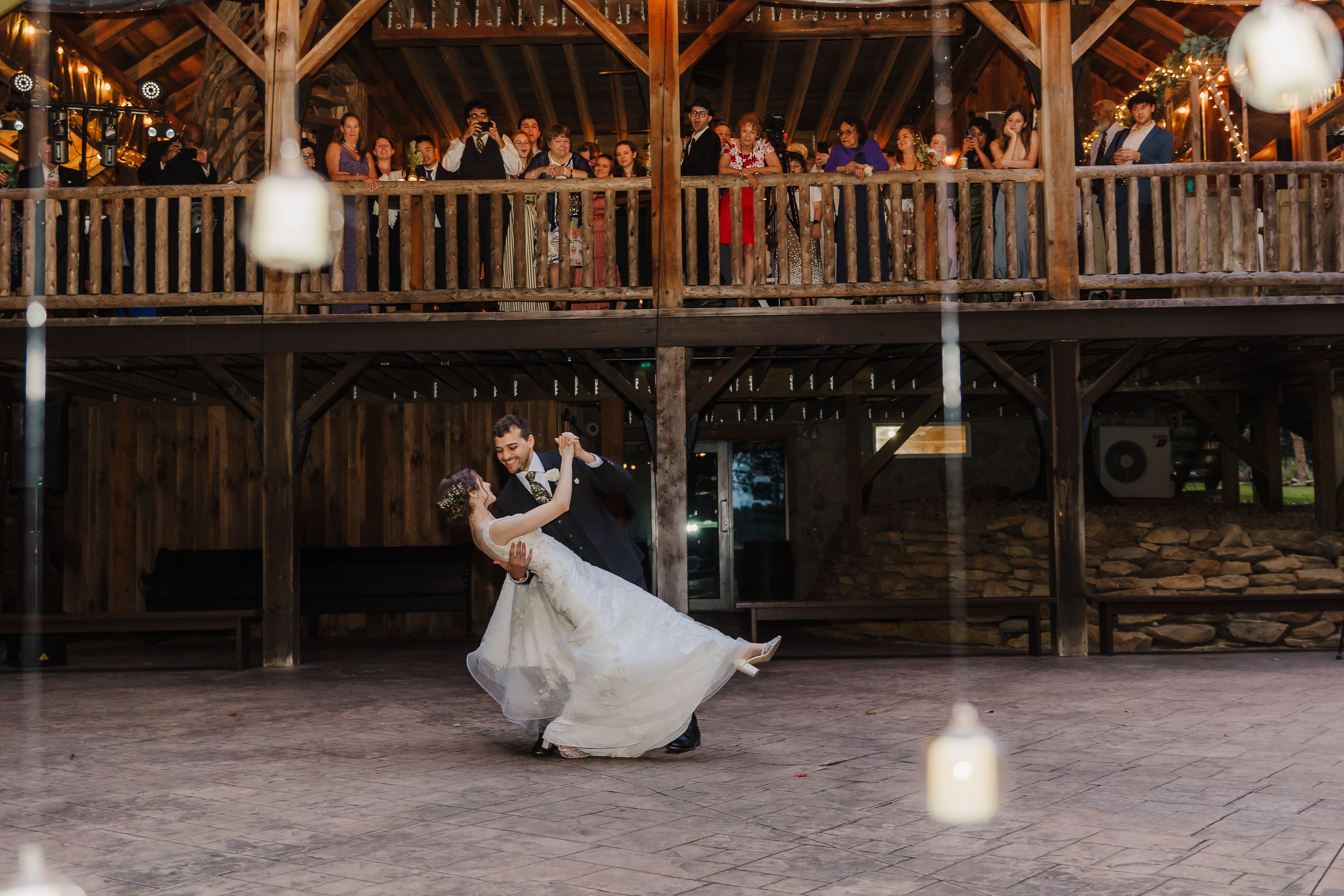 a man and woman dancing in a barn