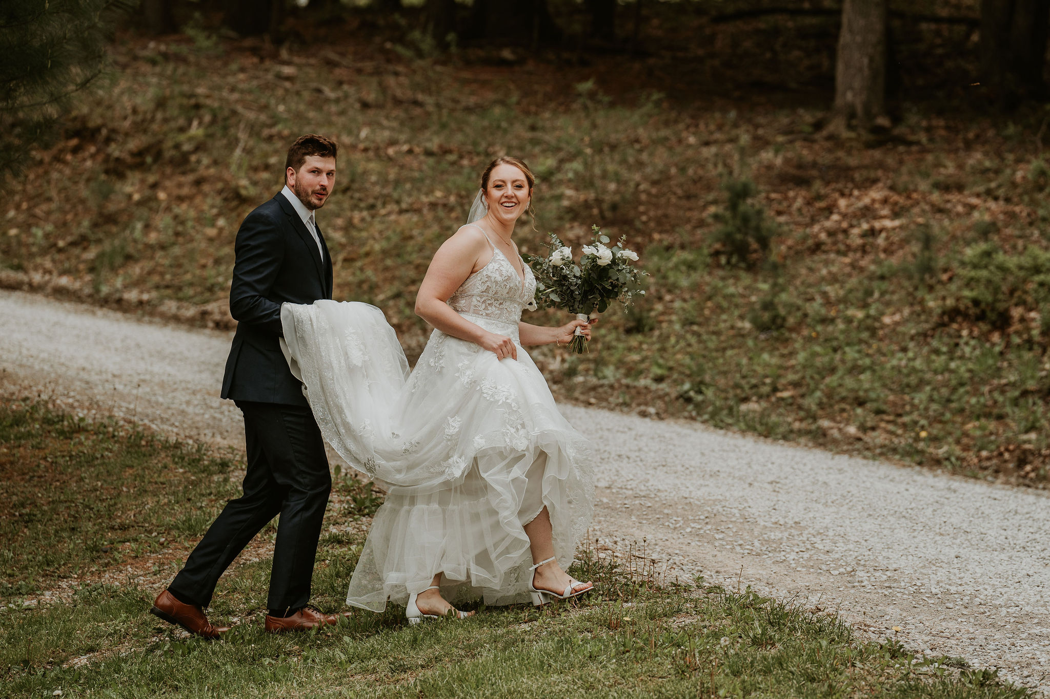 a man and a woman standing in the grass