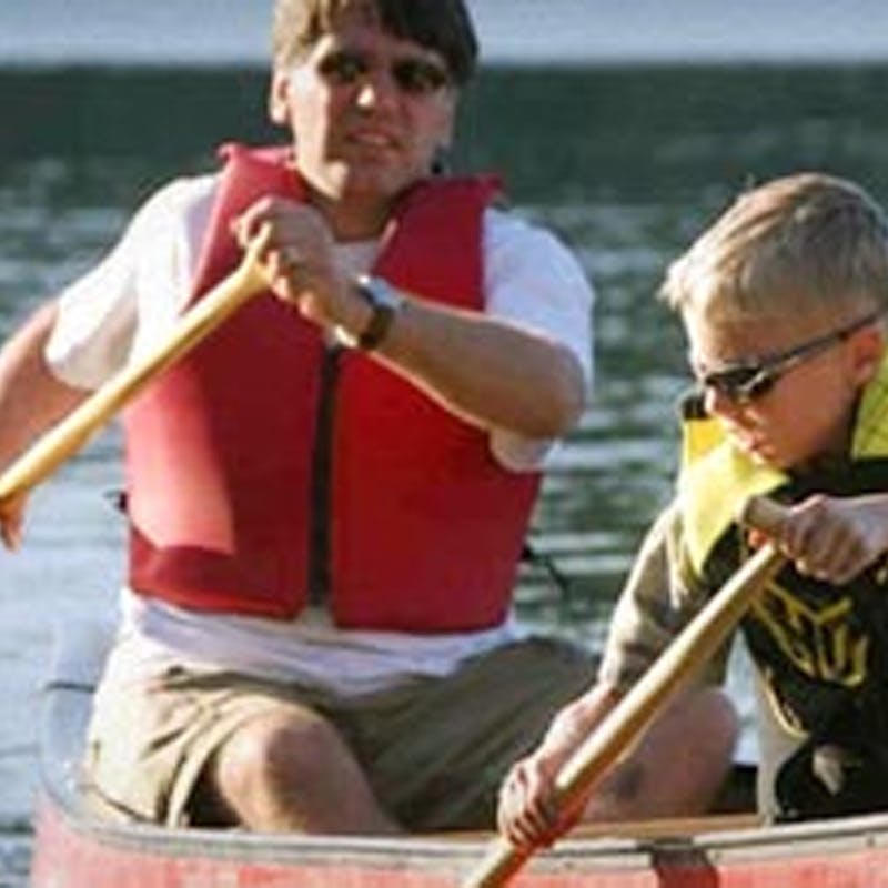 a group of people in a boat on a body of water