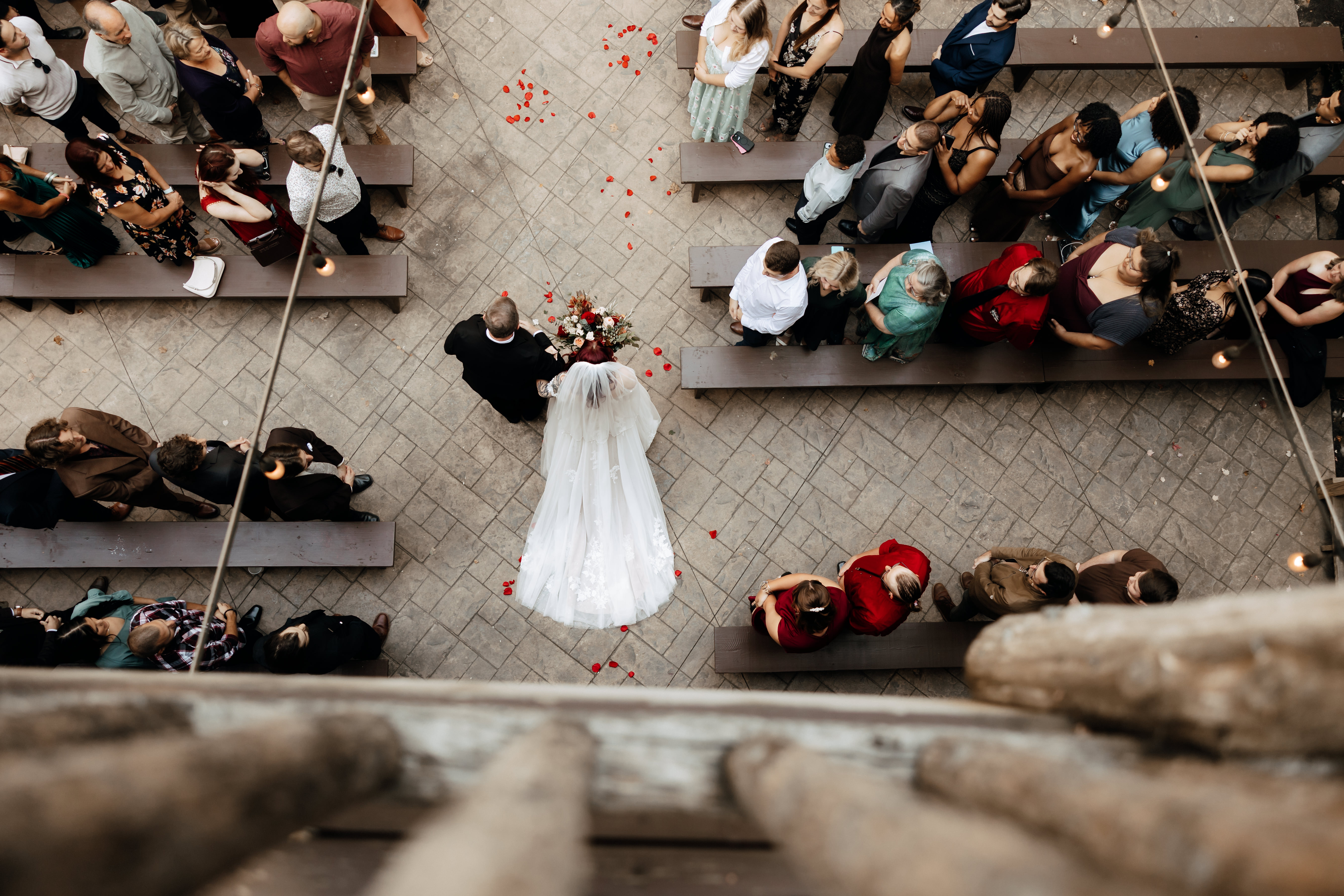a bride and groom walking down the aisle