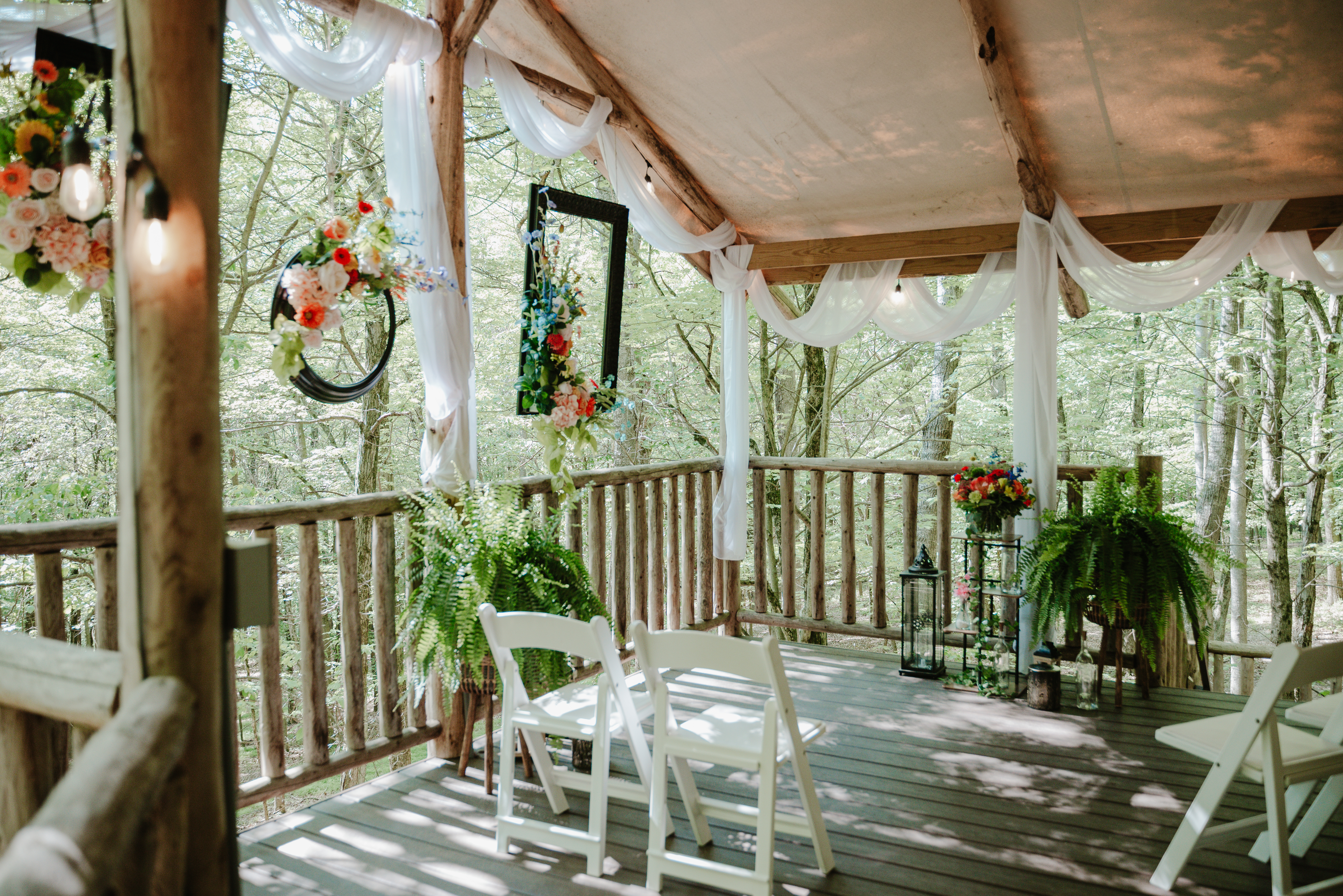 a deck with chairs and flowers