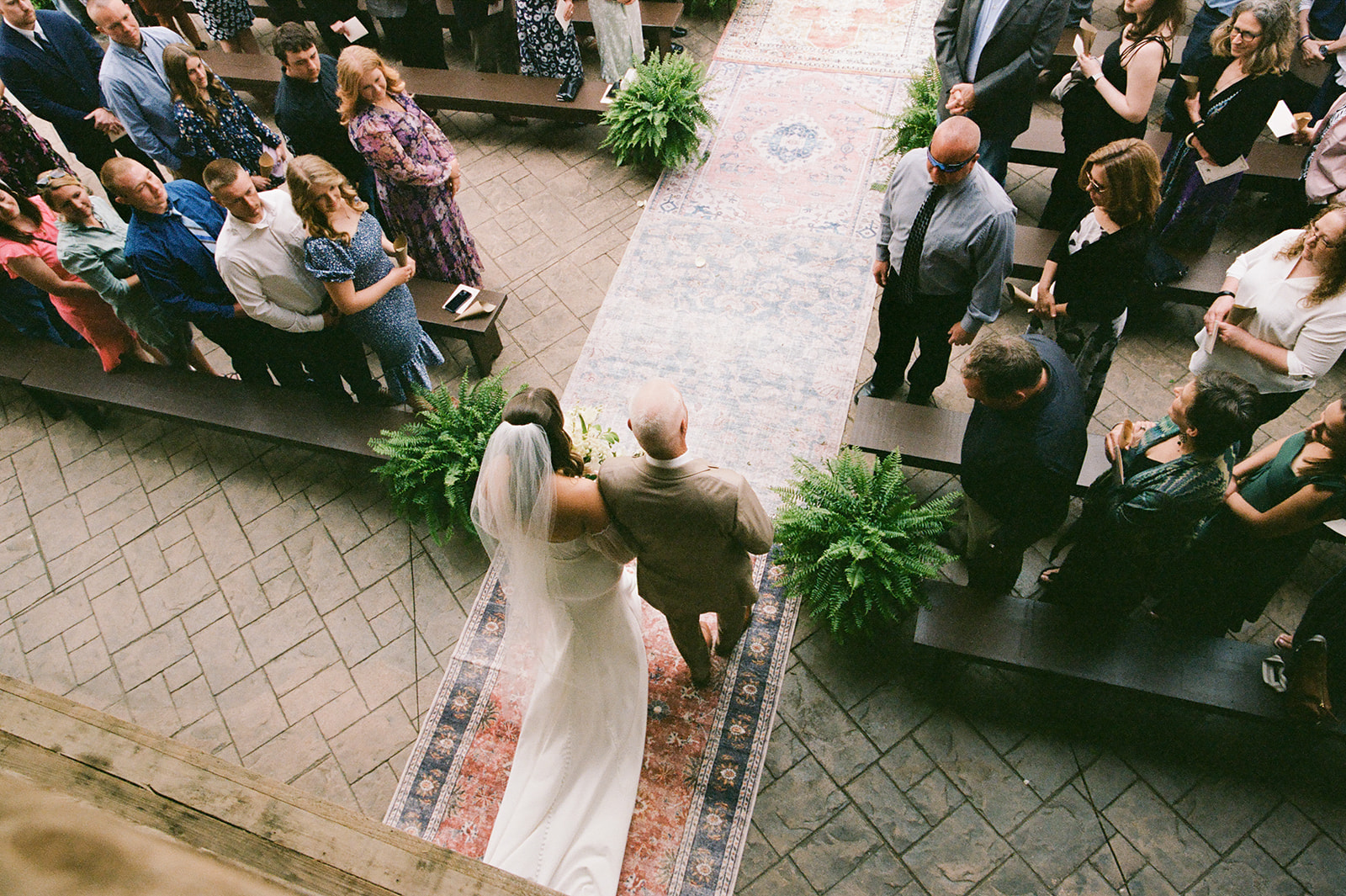 a bride and groom walking down a aisle