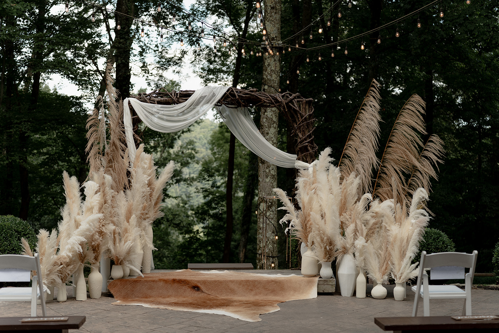 a wedding ceremony with white and brown flowers