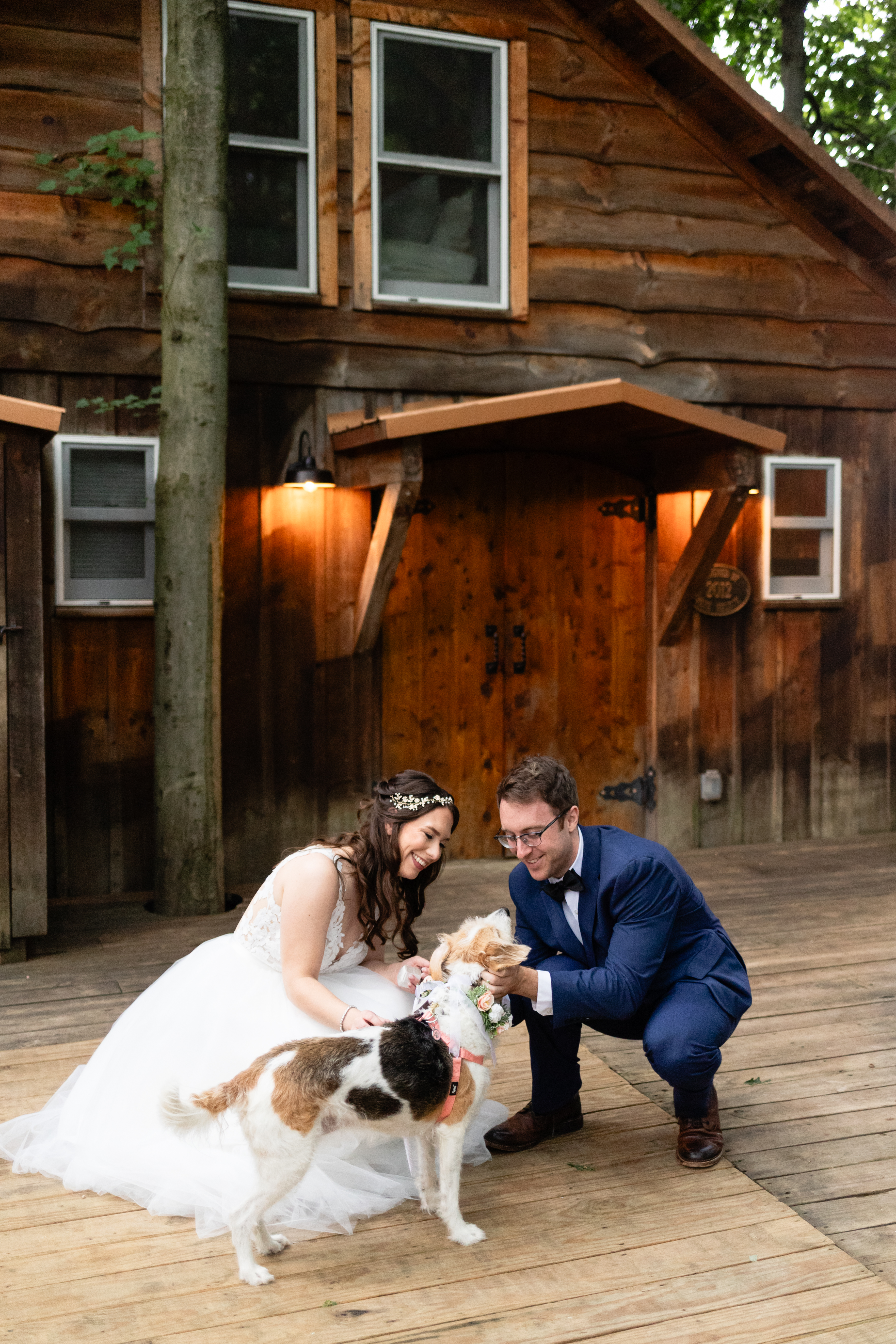 a man and woman in a wedding dress and a dog
