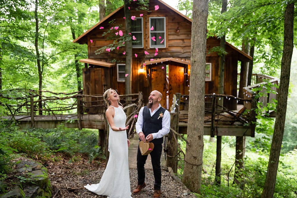 a man and a woman standing in front of a house