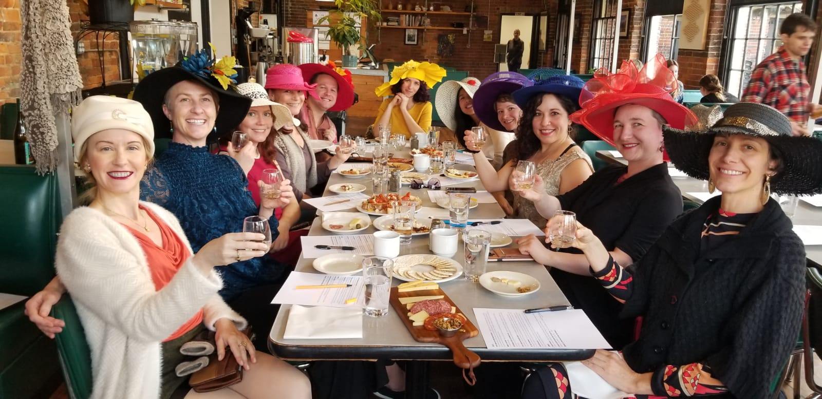 a group of people sitting at a table with food