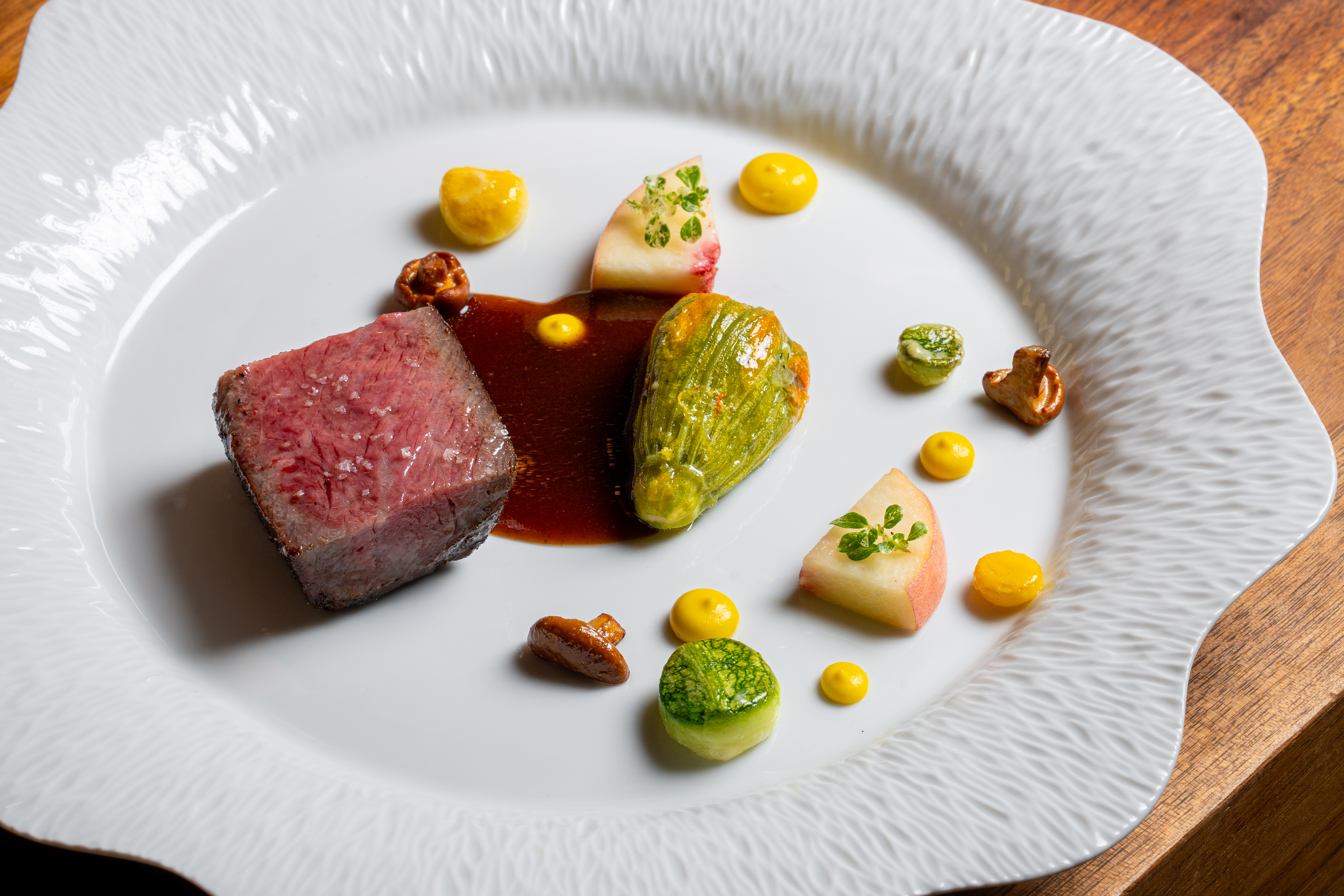a plate of food on a wood table