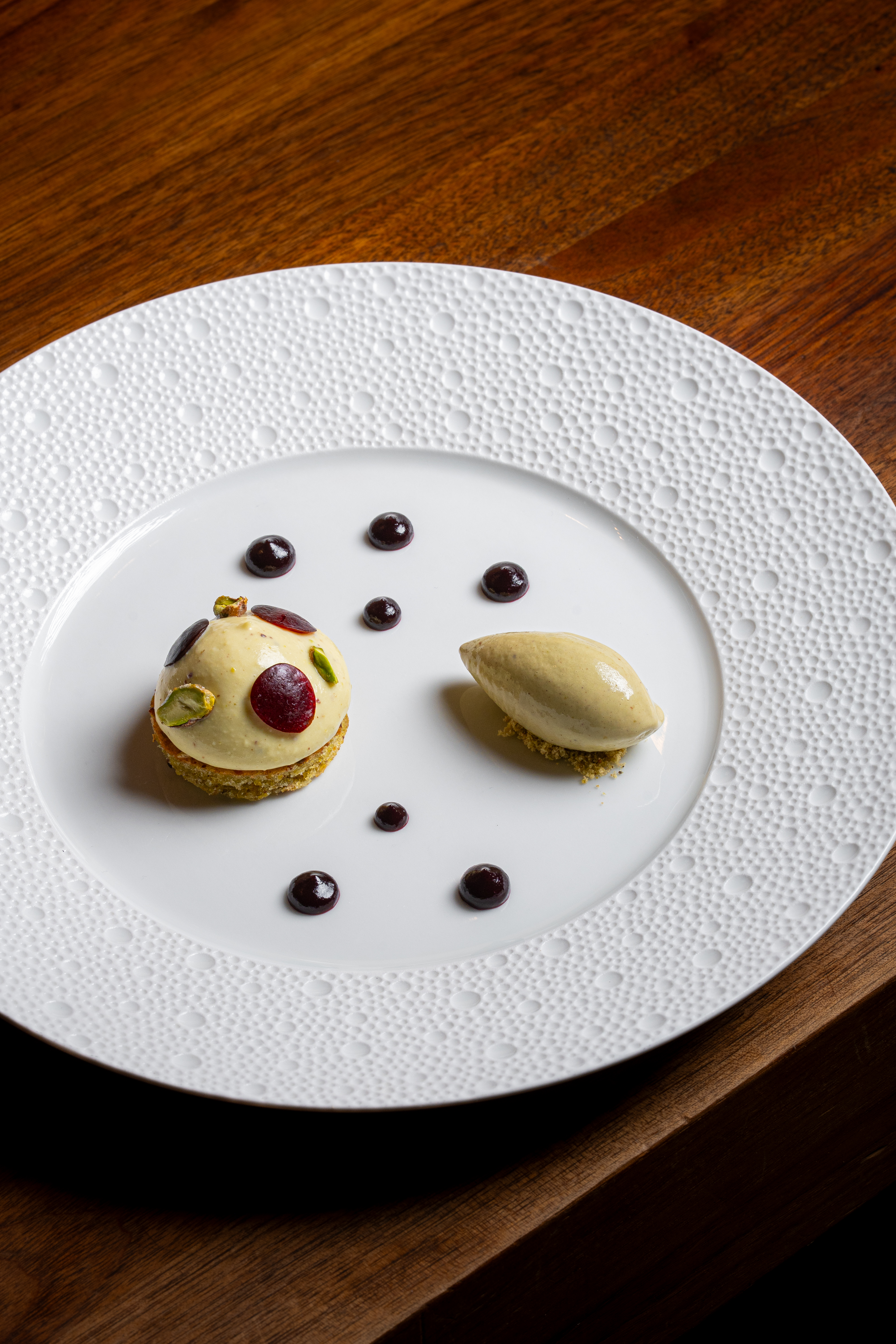 a plate of desserts on a wood table