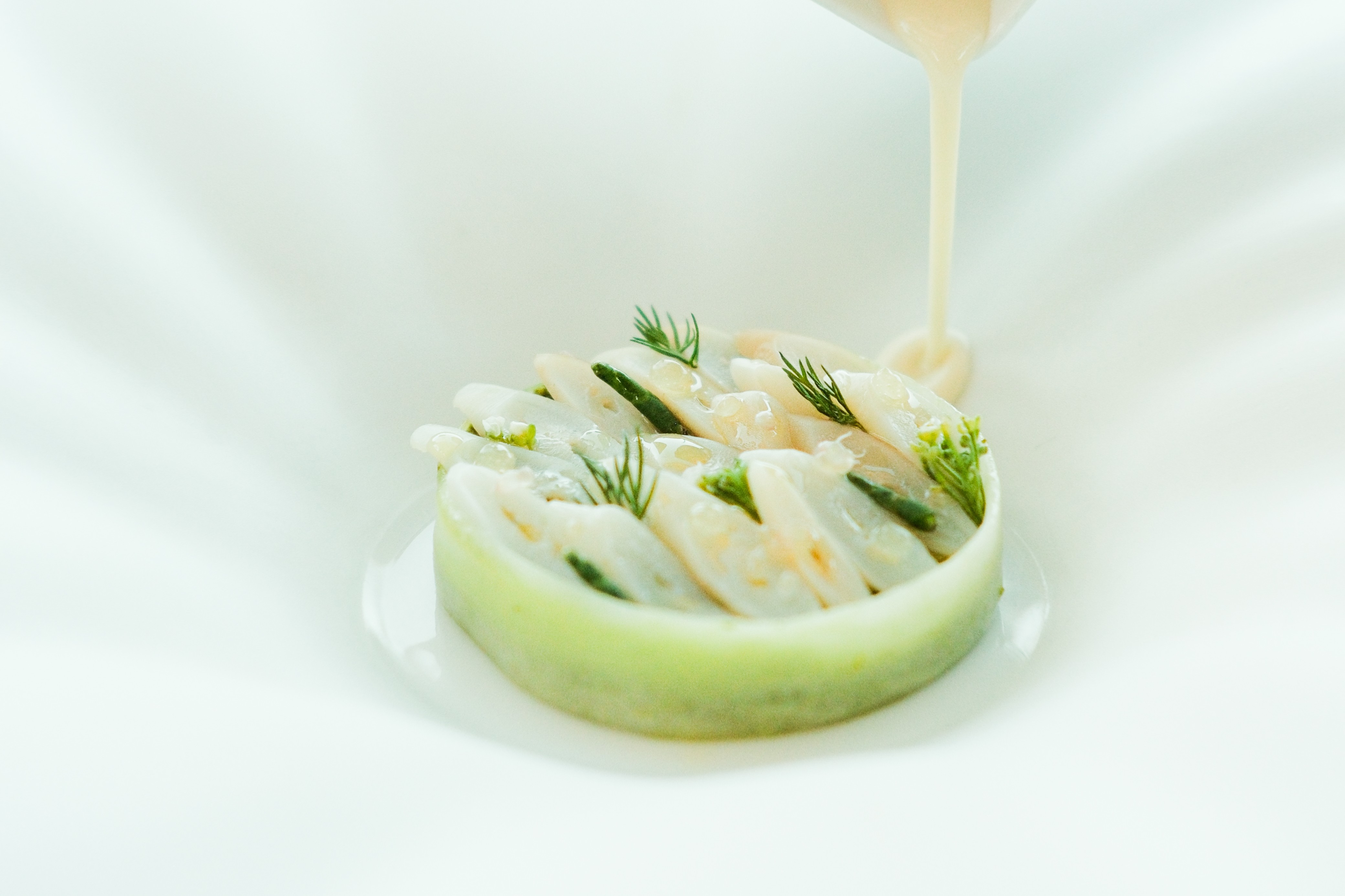 a plate of food with sauce pouring