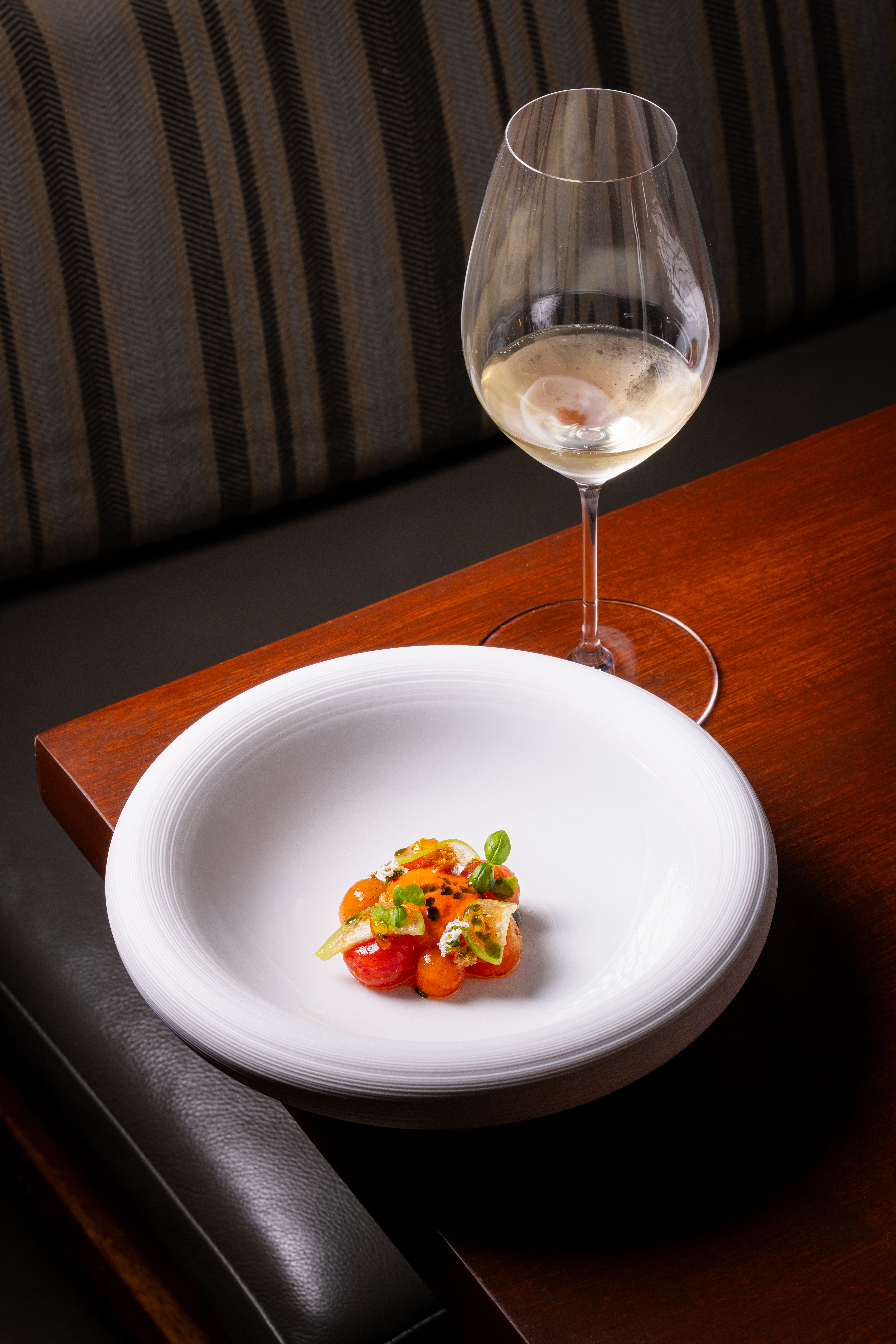 a plate of food and a glass of wine