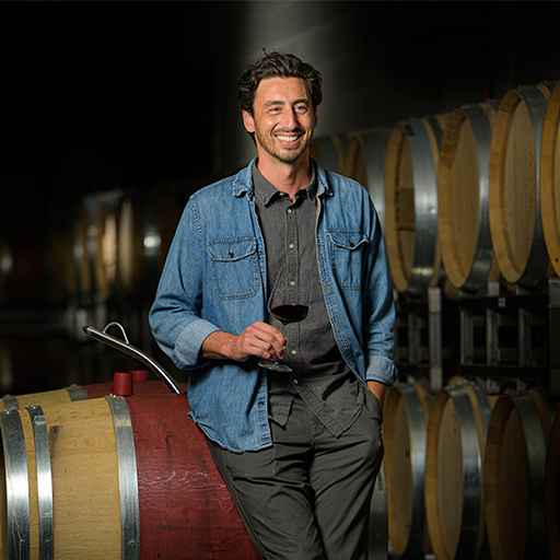 a man holding a wine glass and smiling