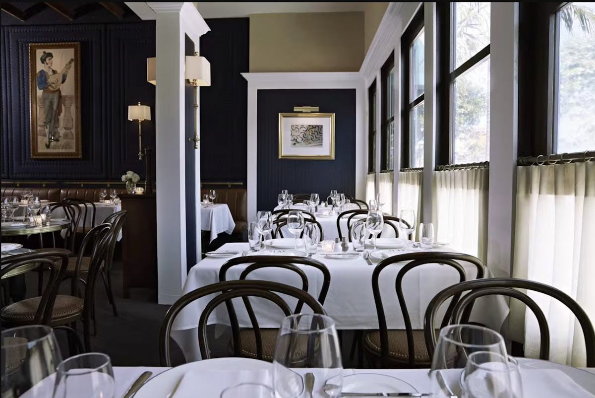 a dining room table in front of a window