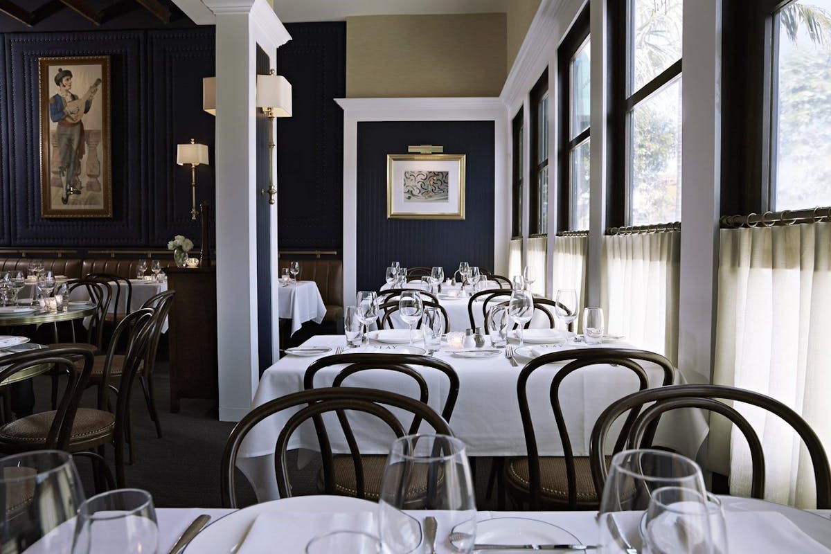 a dining room table in front of a window