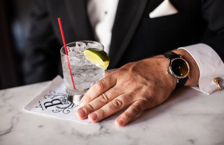 a hand holding a cocktail