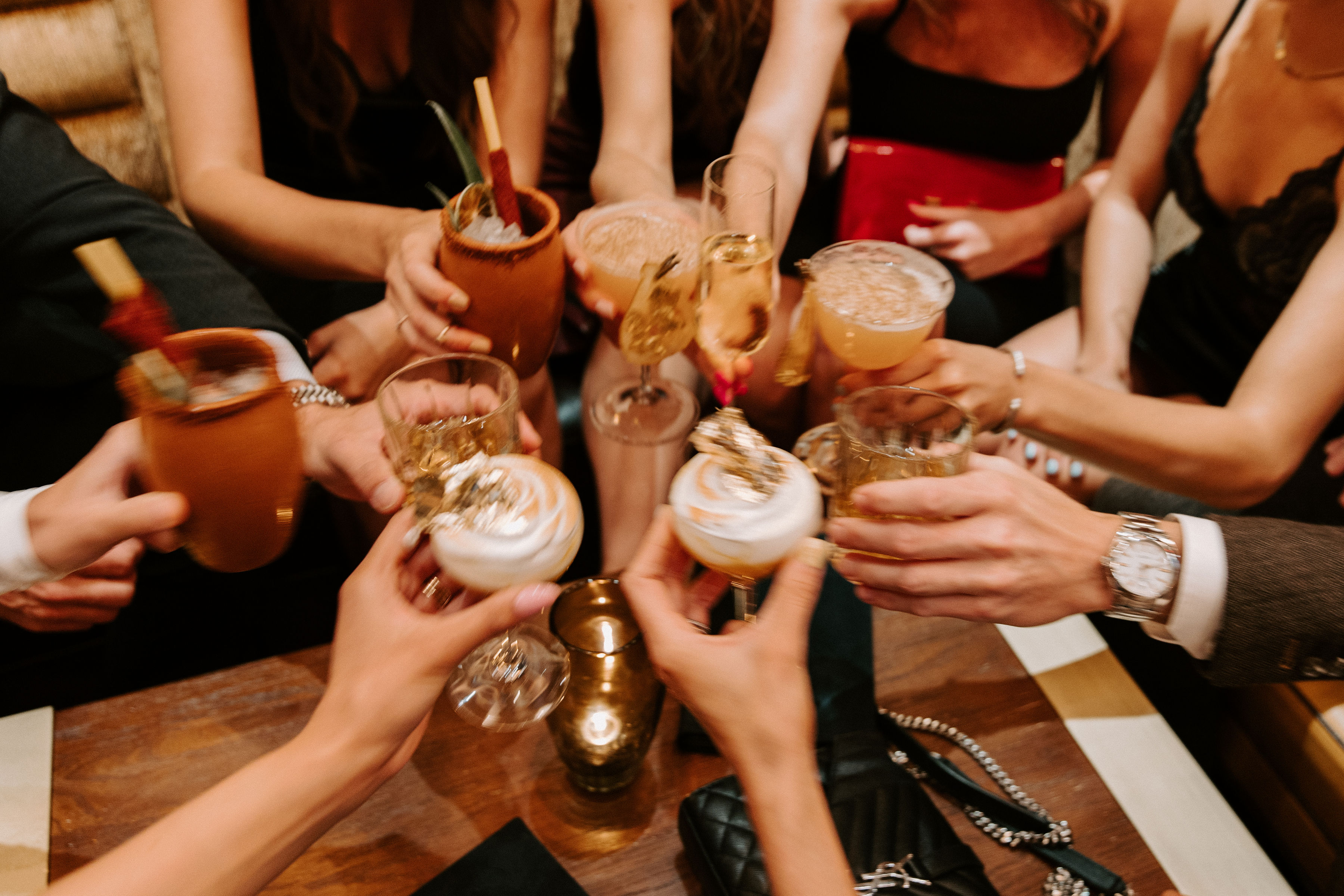 group of people holding up drinks for a celebration