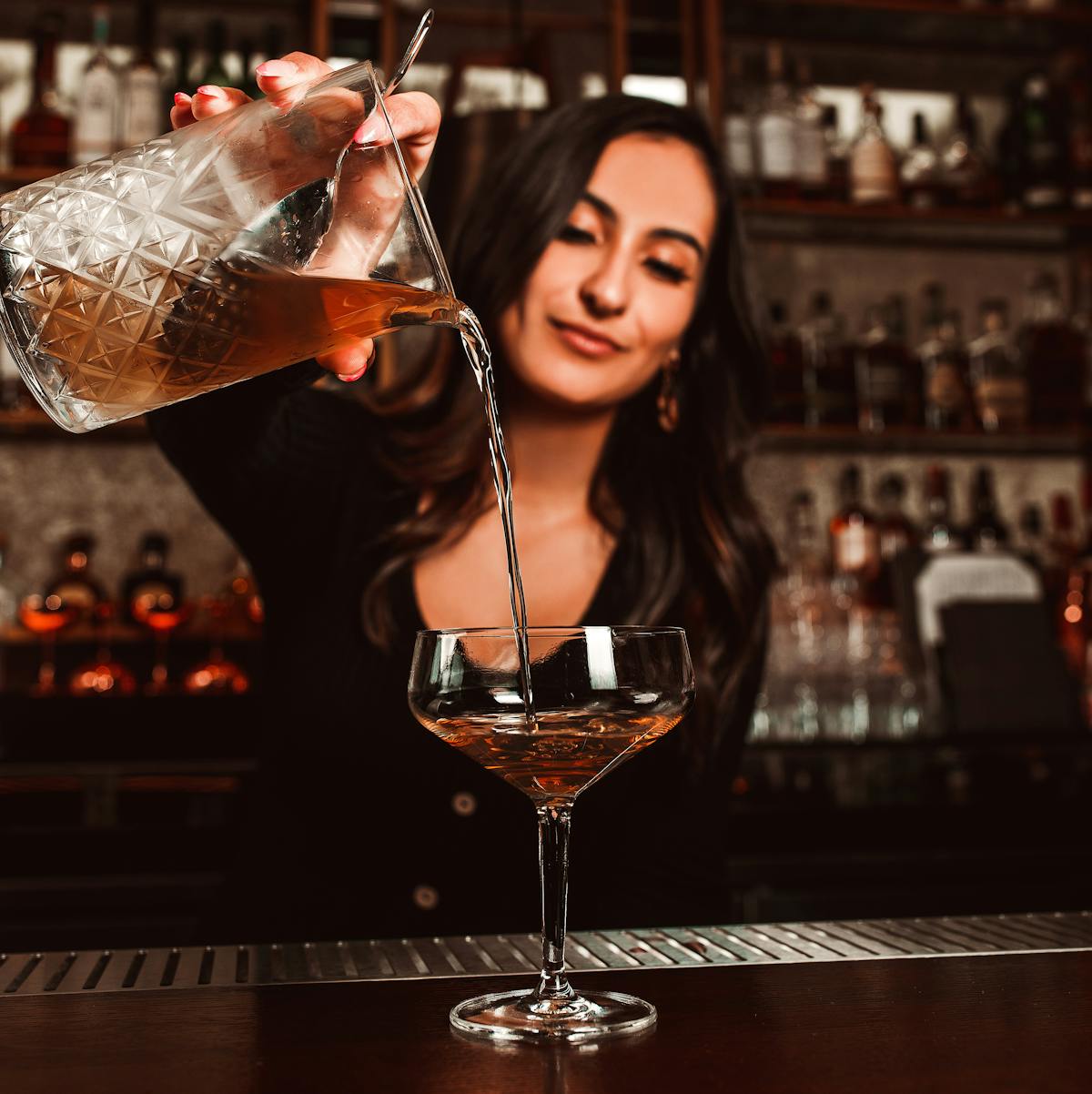 a person sitting at a table with wine glasses