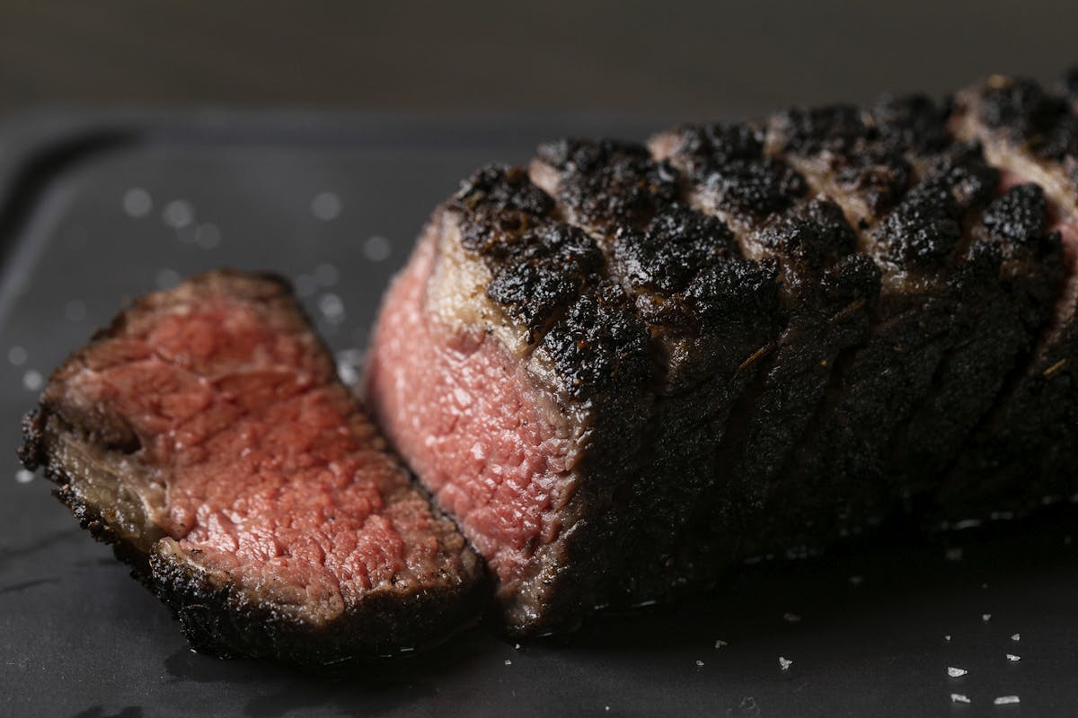 a close up of a steak on a platter