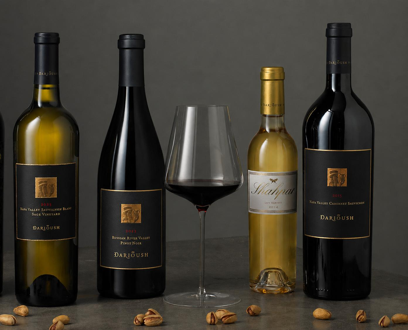 a group of wine bottles and a glass of wine