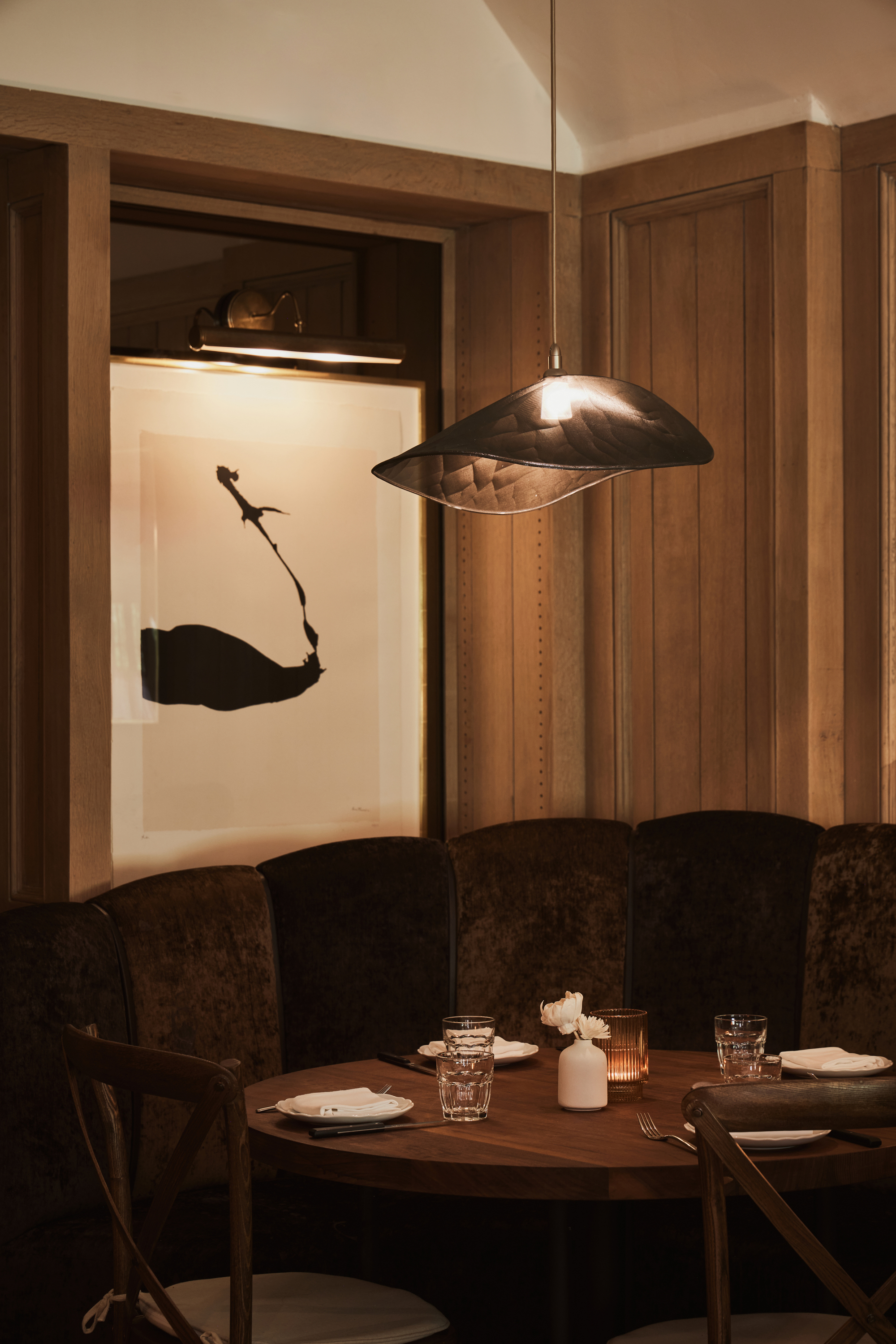 a kitchen with a sink and a mirror in a dark room