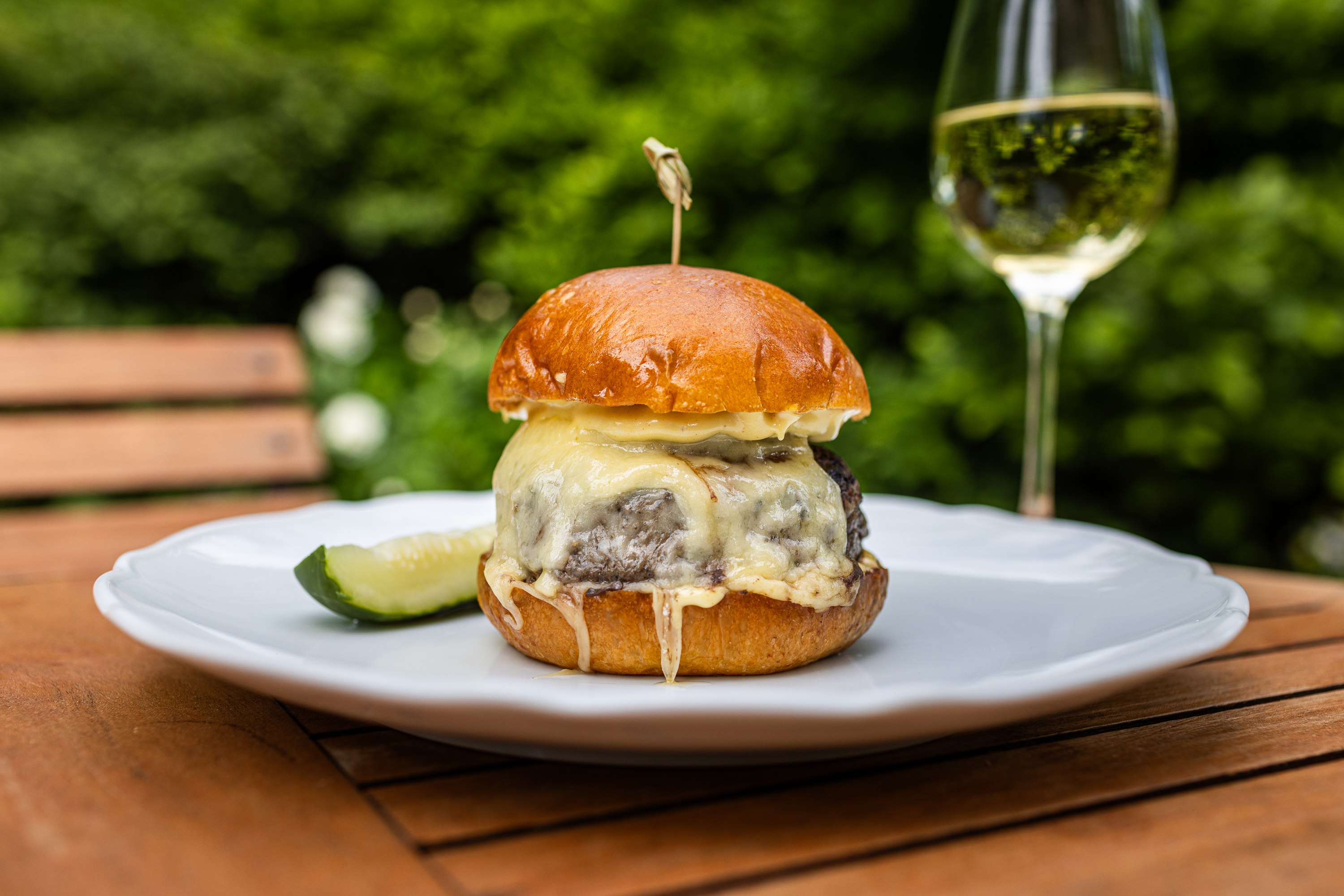 a close up of a plate of food and a glass of wine