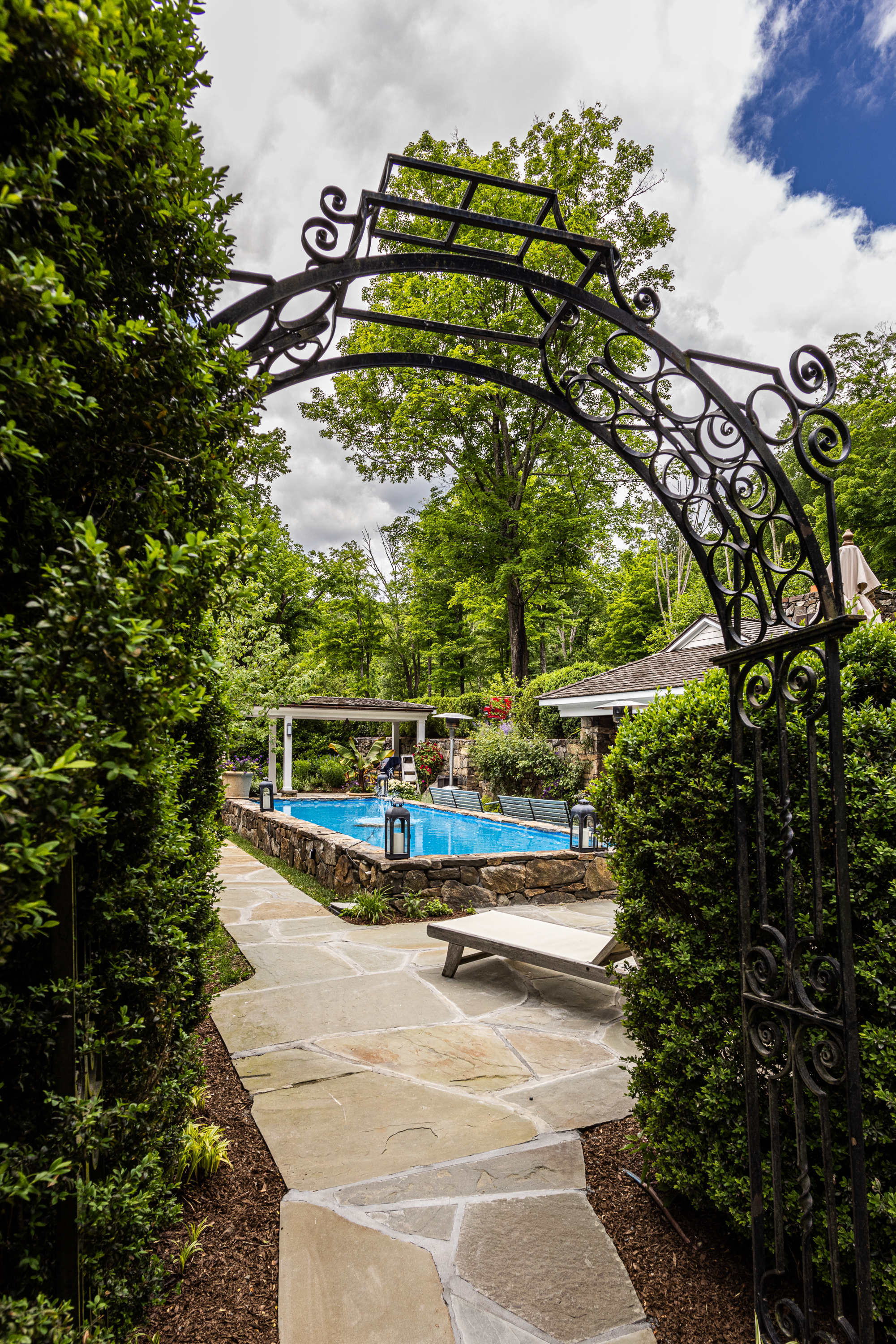 a bus driving down a street next to a tree