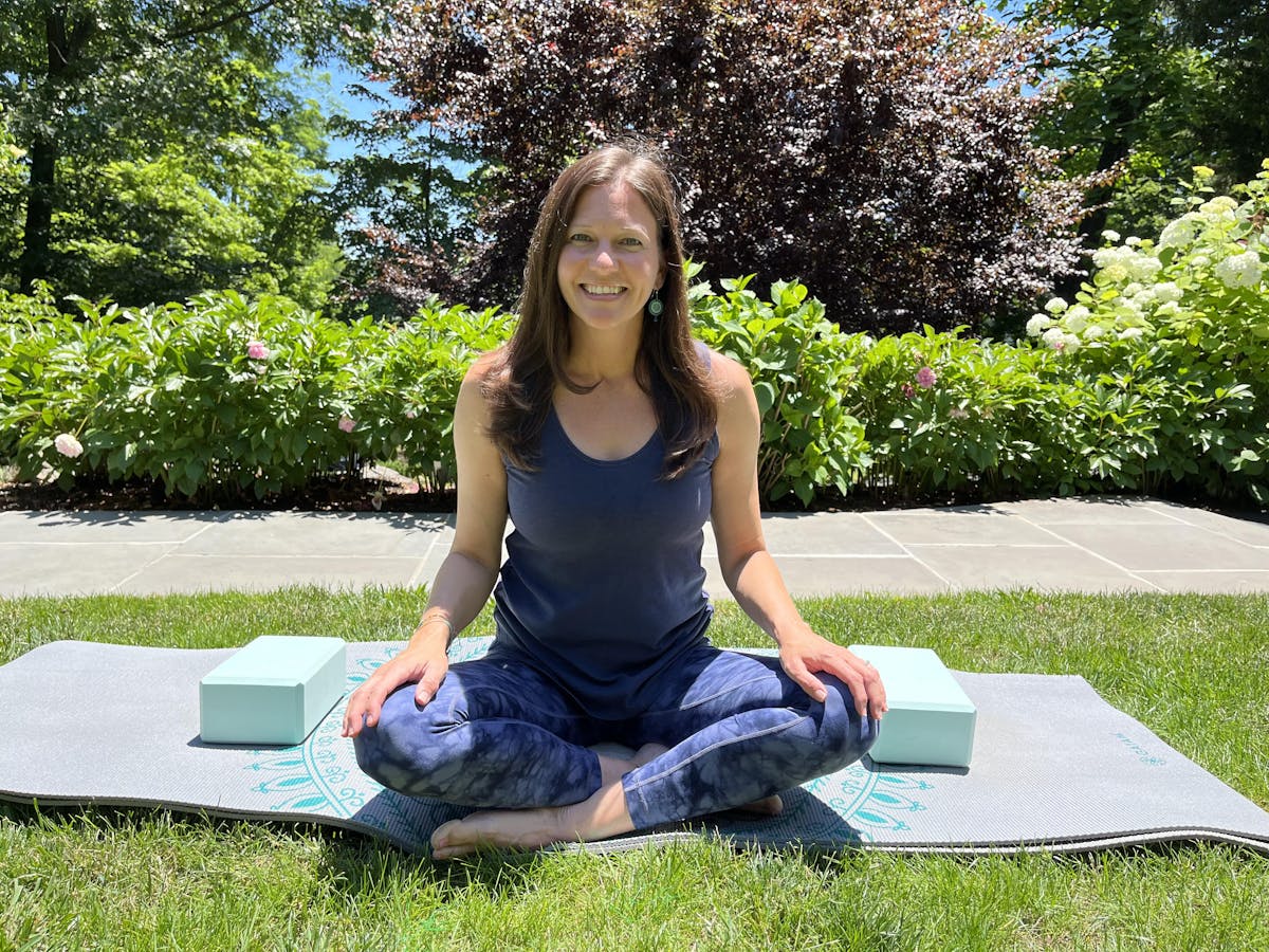 a woman sitting on a bench posing for the camera