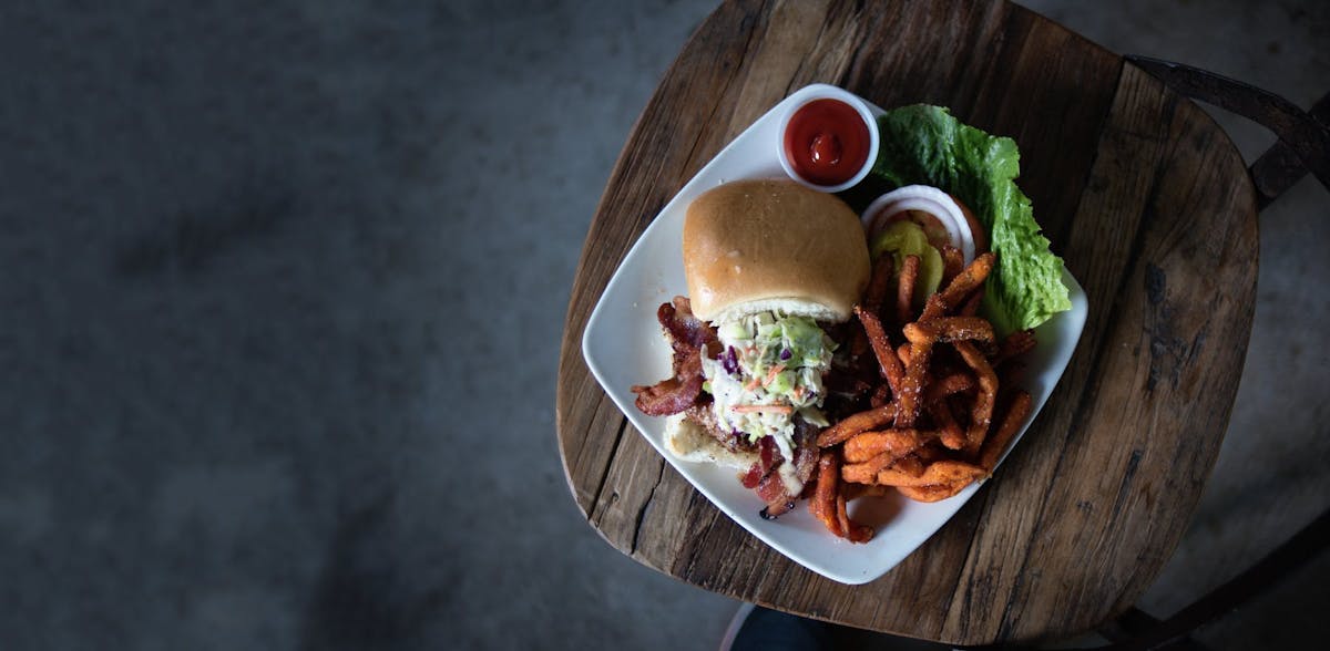 a plate of food sitting on top of a wooden table