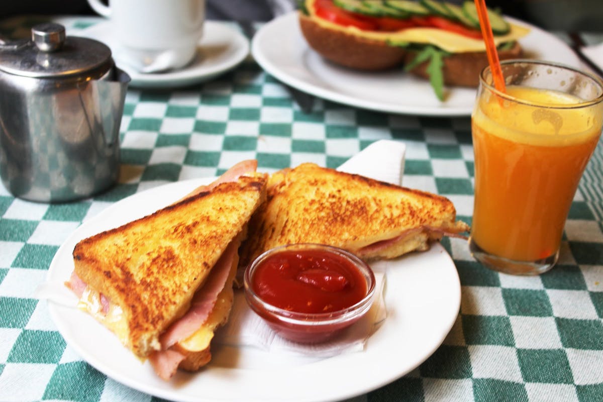 a close up of a plate of food and a cup of coffee