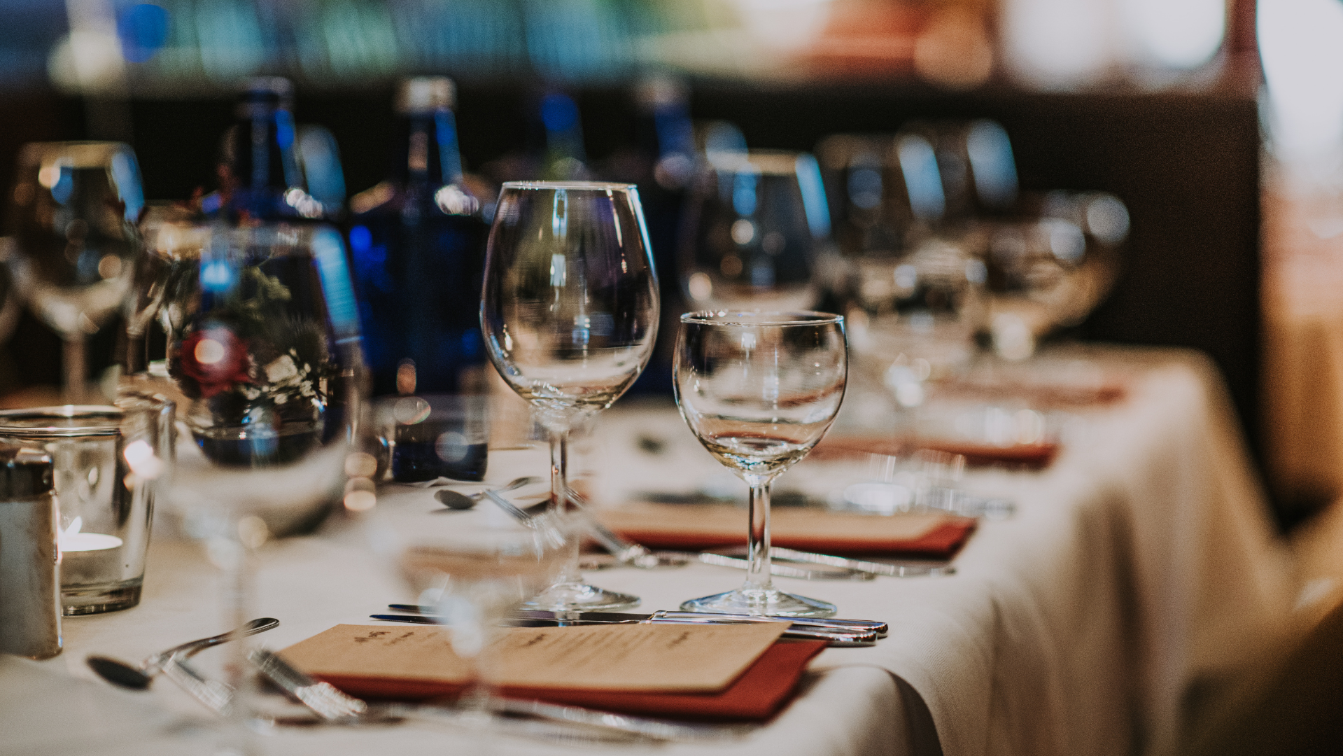 a table with wine glasses and utensils