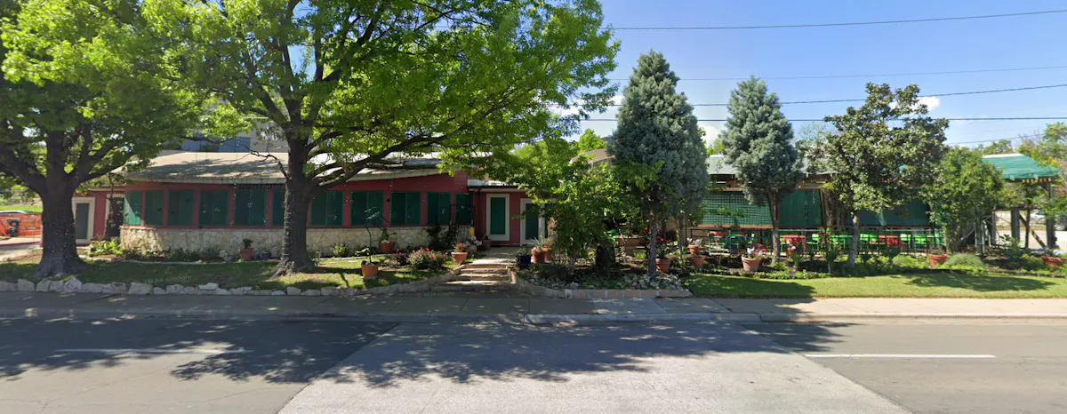 a house with a tree and a street