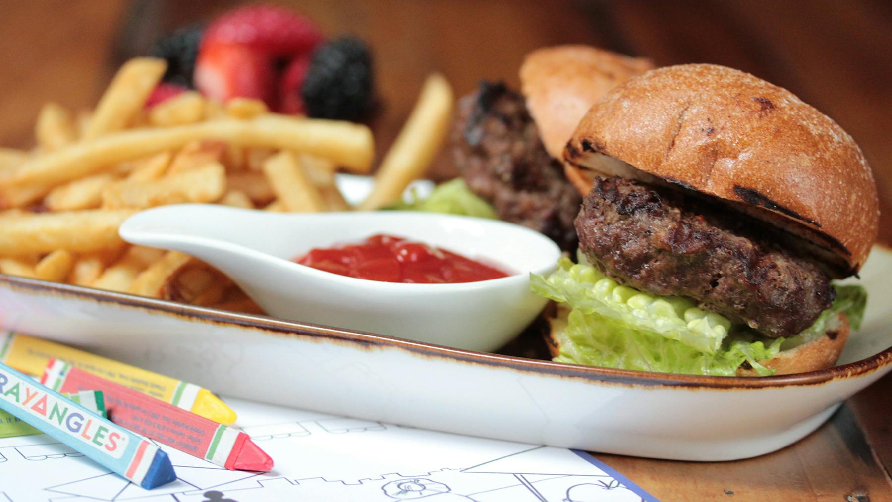 a close up of a sandwich and fries on a plate