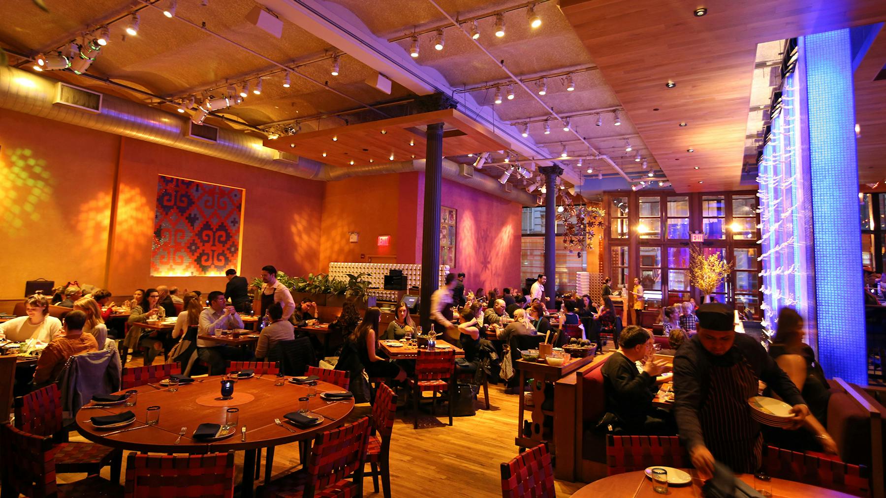 a group of people sitting at a table in a restaurant