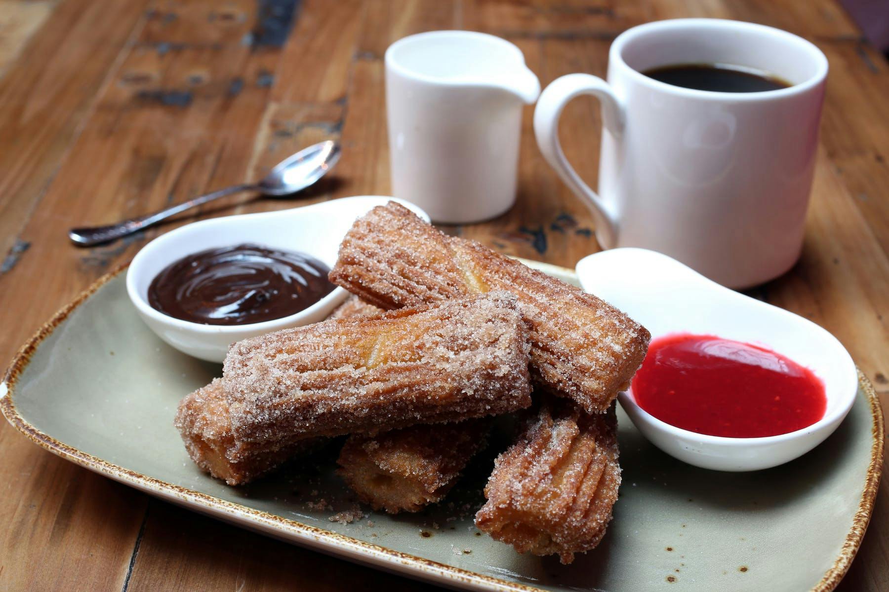 Churros with two sauces on a plate